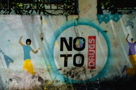 Graffiti art with "no to drugs" message and dancing figures.