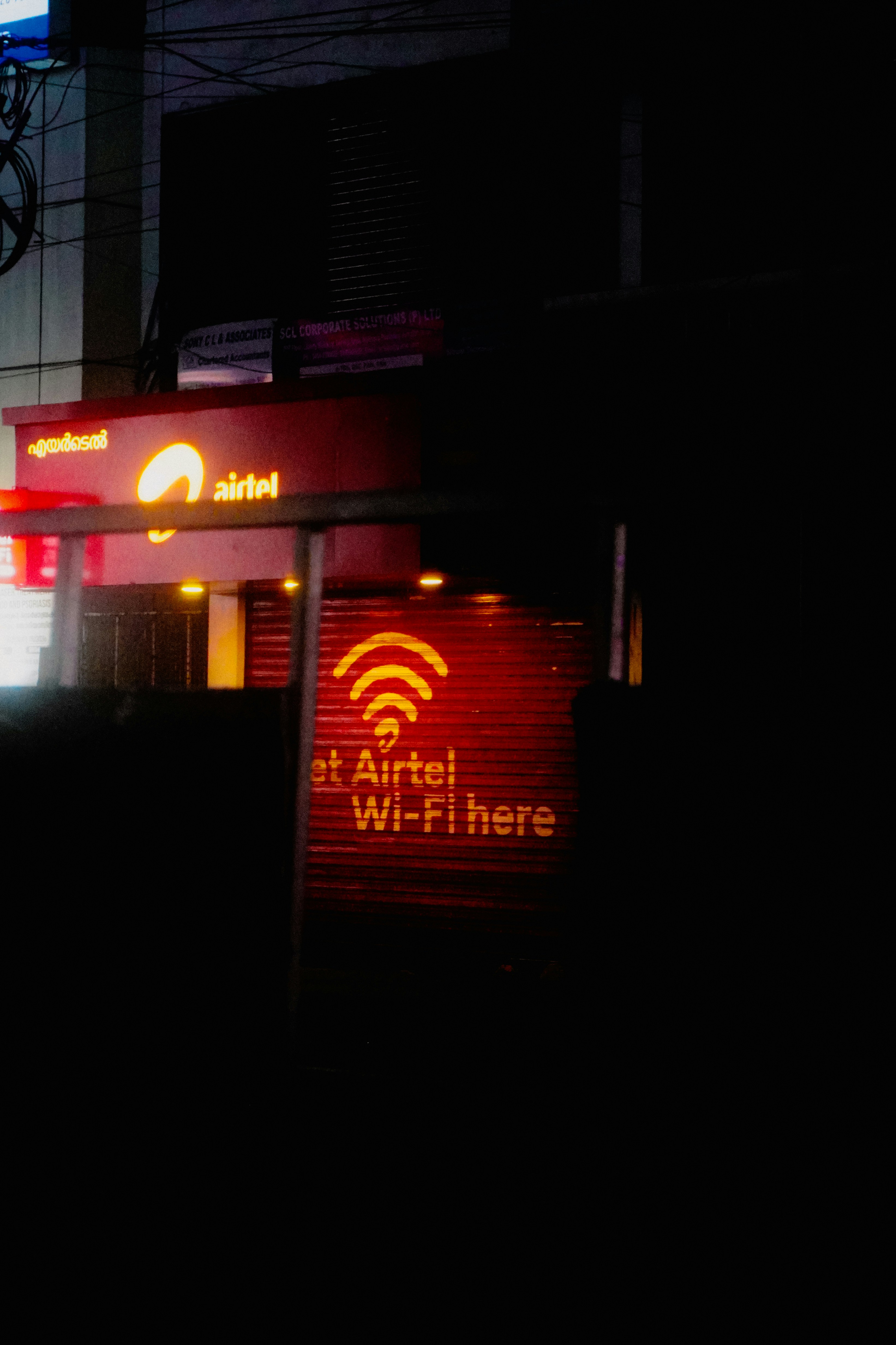 Airtel wi-fi sign illuminated at night.