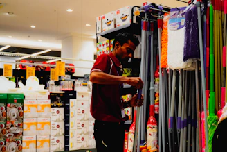 Man arranging cleaning supplies in a store