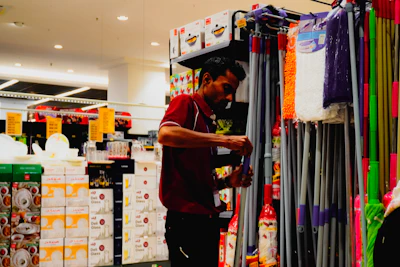 Man arranging cleaning supplies in a store