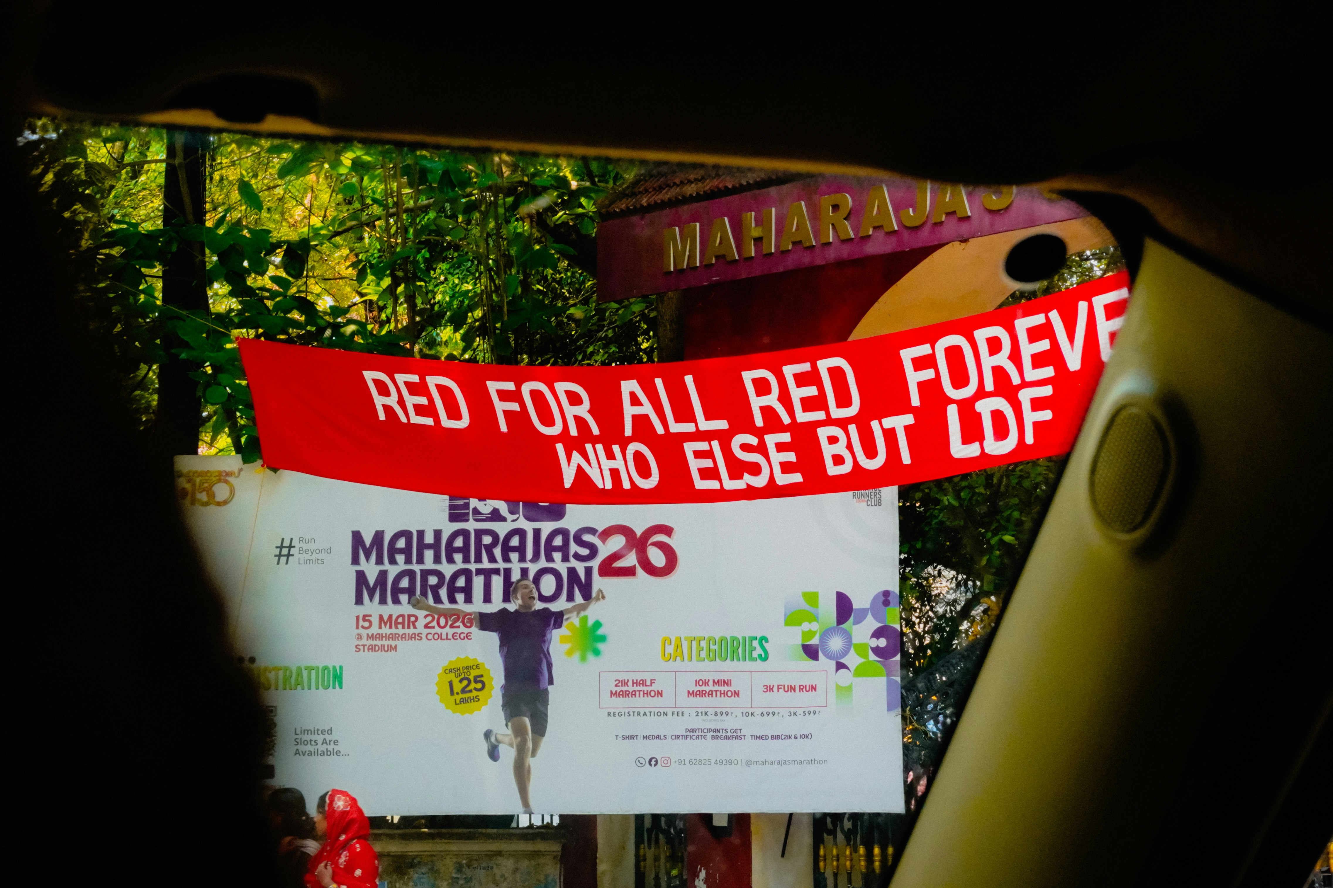 Red banner with text over marathon advertisement