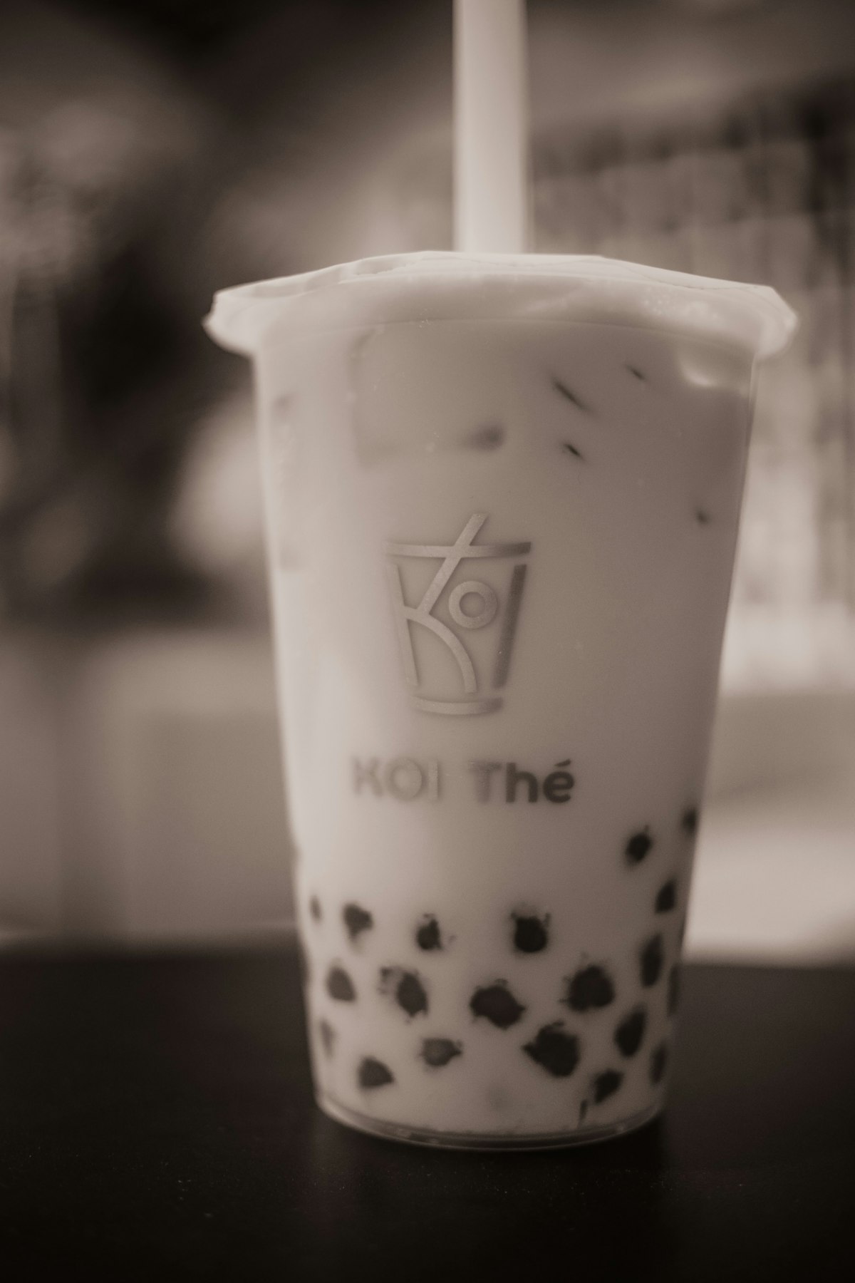 A cup of bubble tea with visible tapioca pearls