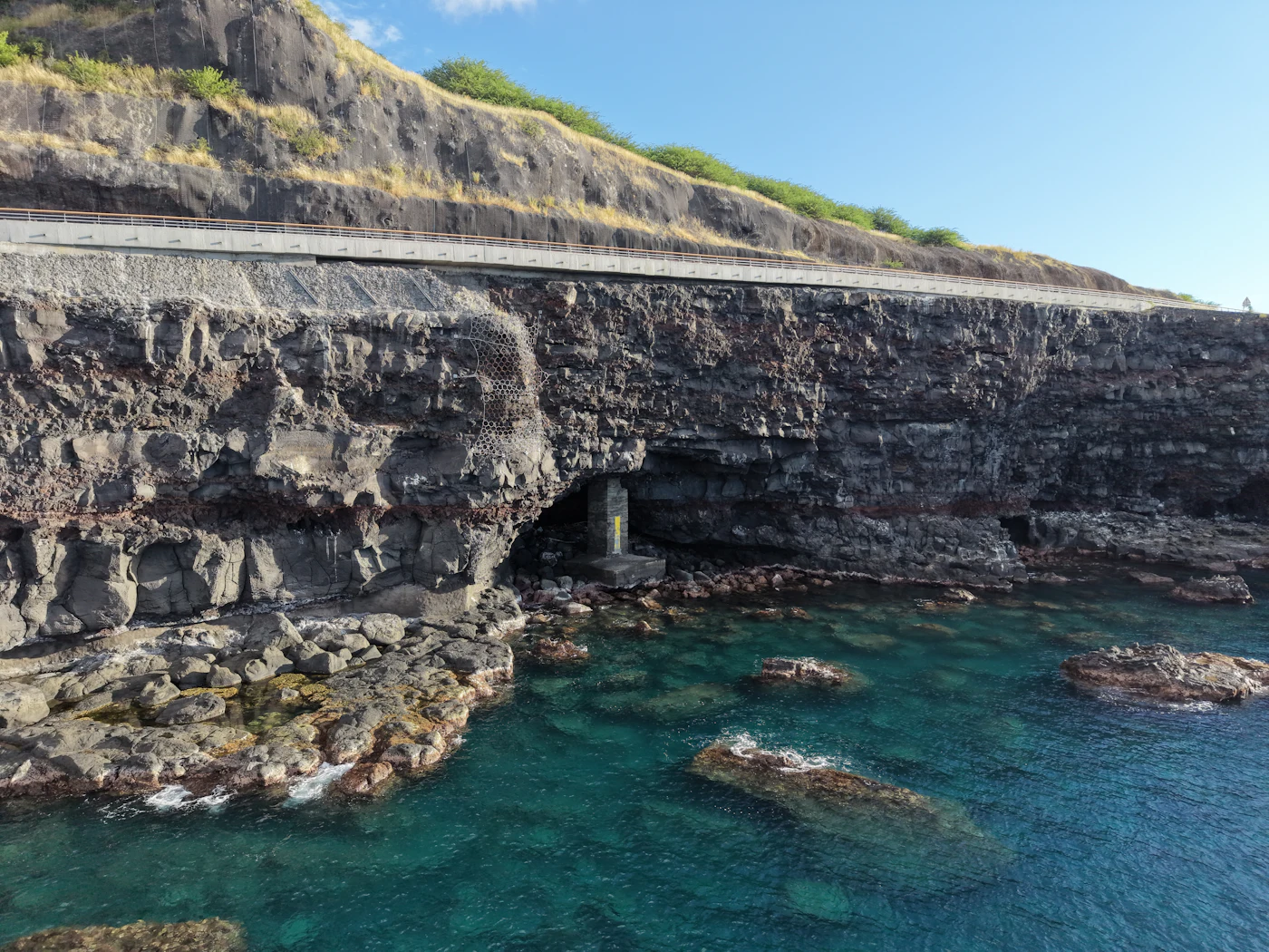 Clear lagoon water below basalt cliffs at Boucan Canot, Reunion