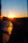 Curving road with sunset reflecting on wet asphalt