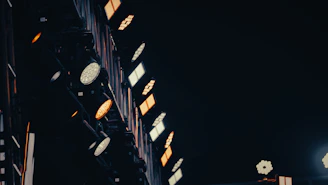Stage lights illuminate a dark venue with warm glow