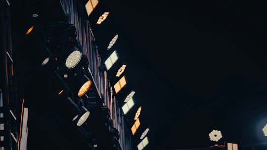 Stage lights illuminate a dark venue with warm glow