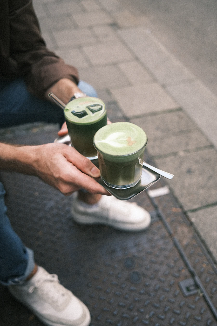 Two matcha lattes on a tray