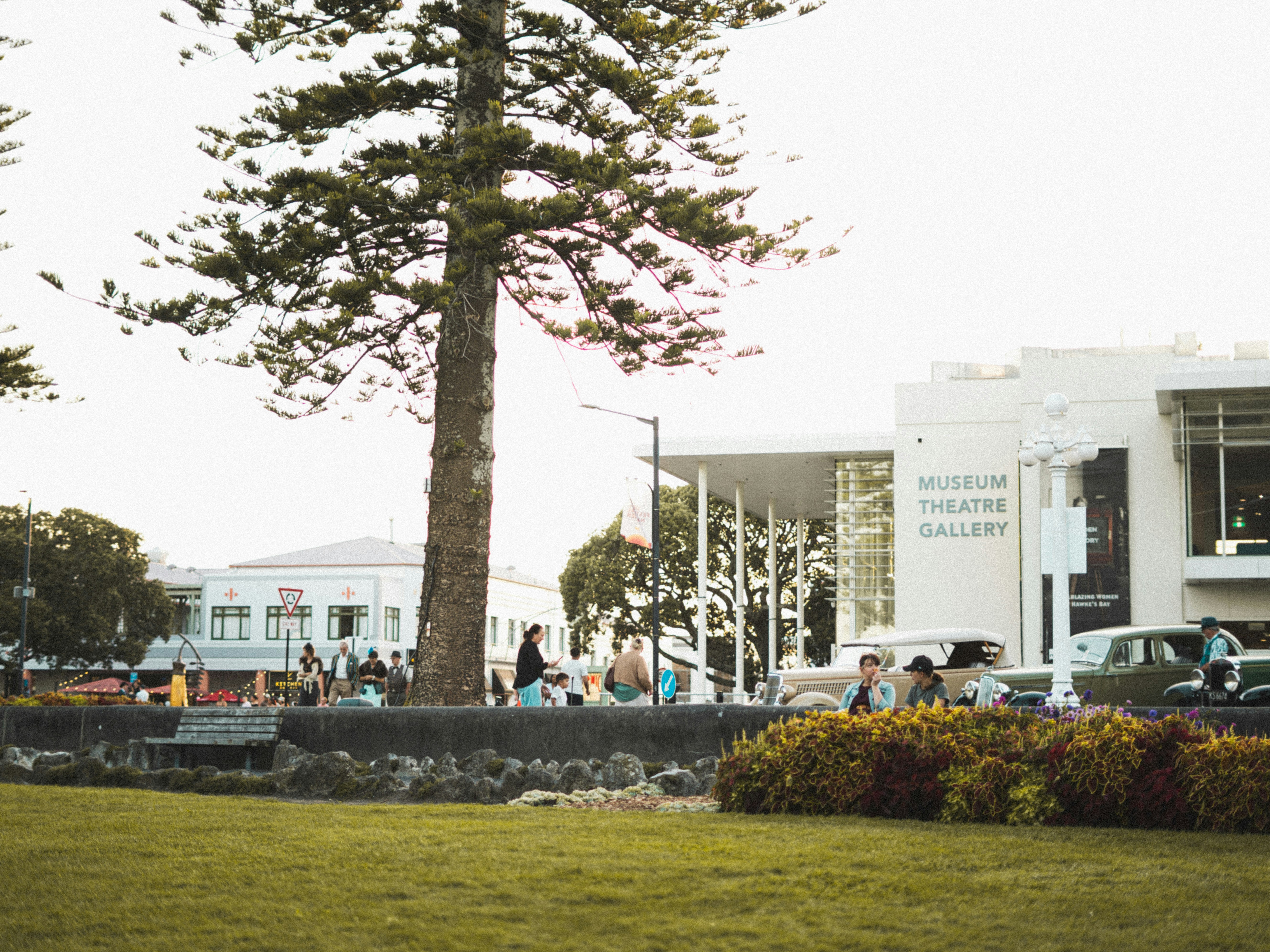 People gathered outside a museum theatre gallery building.
