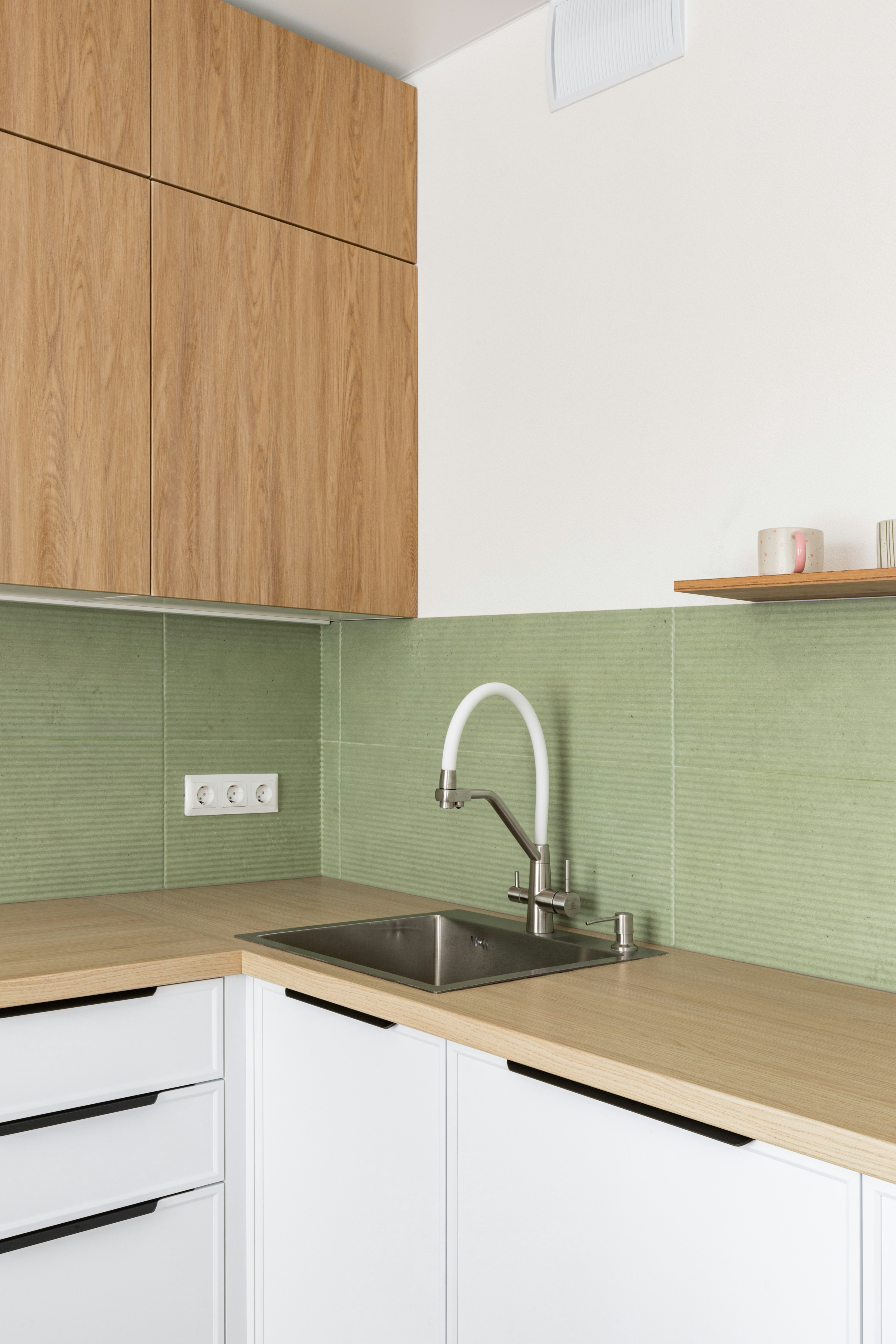 Modern kitchen sink with wooden cabinets and white cabinets