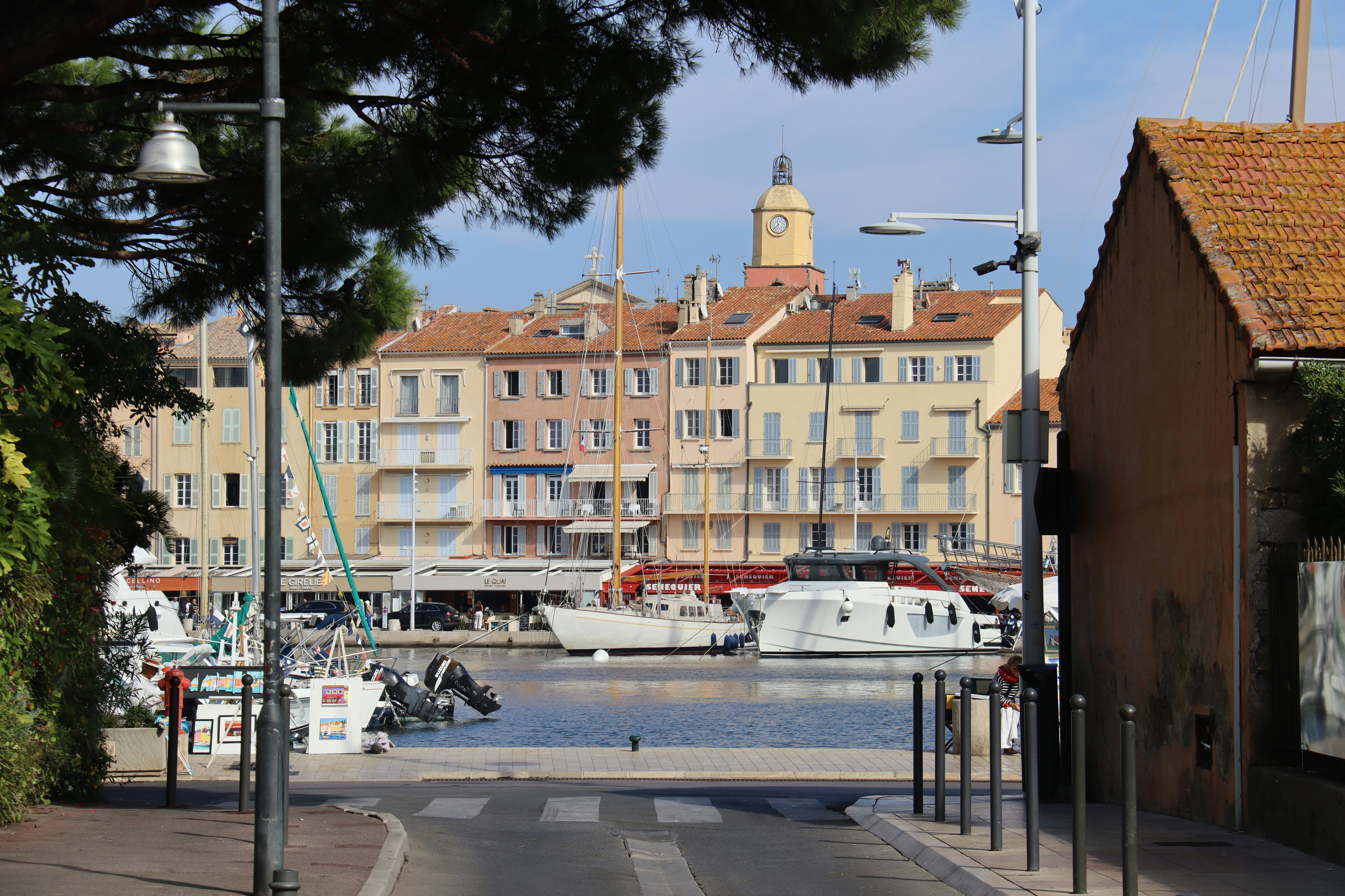 Colorful buildings line a harbor with docked boats.