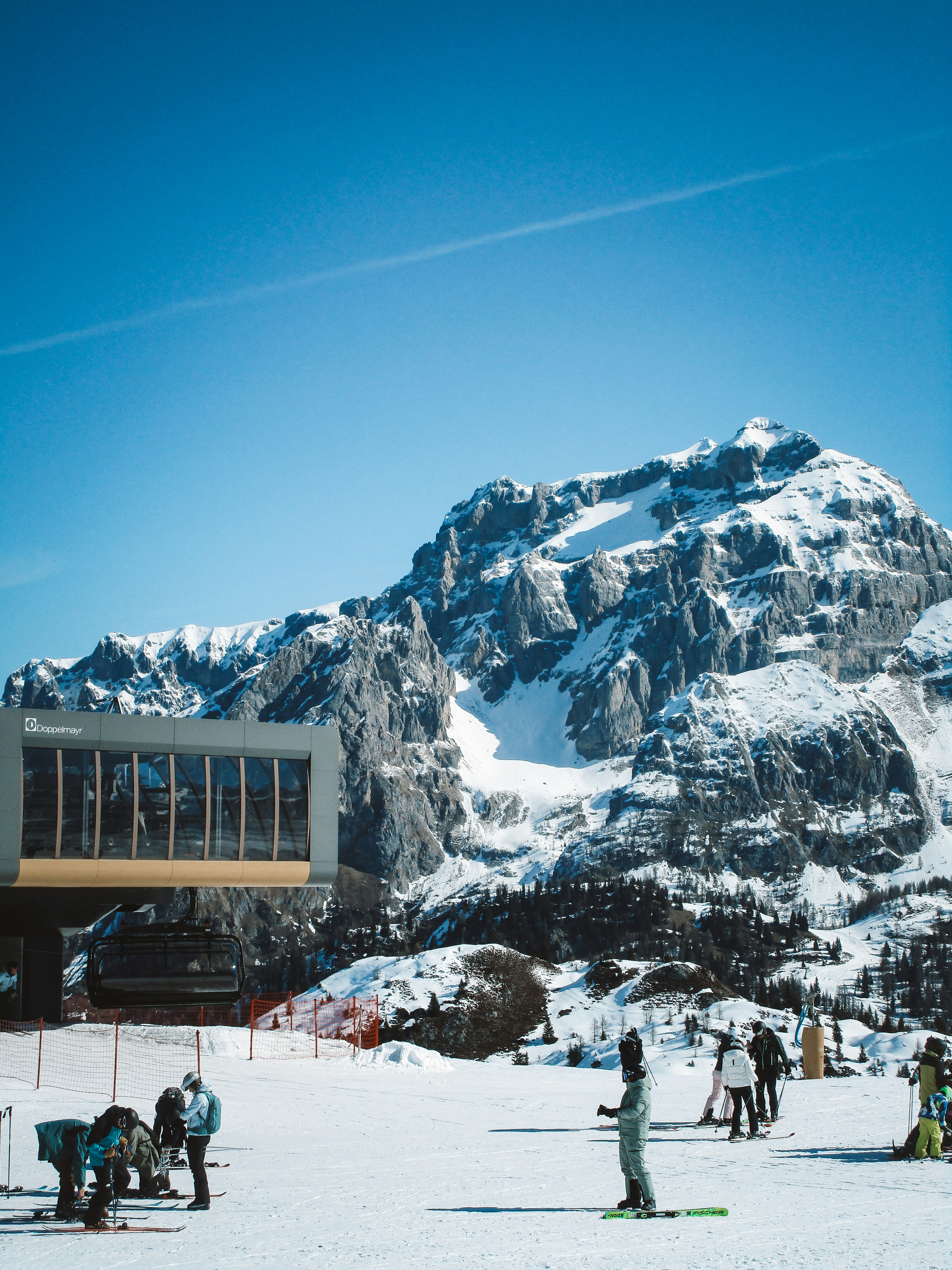 Ski resort with snow-capped mountains and clear blue sky
