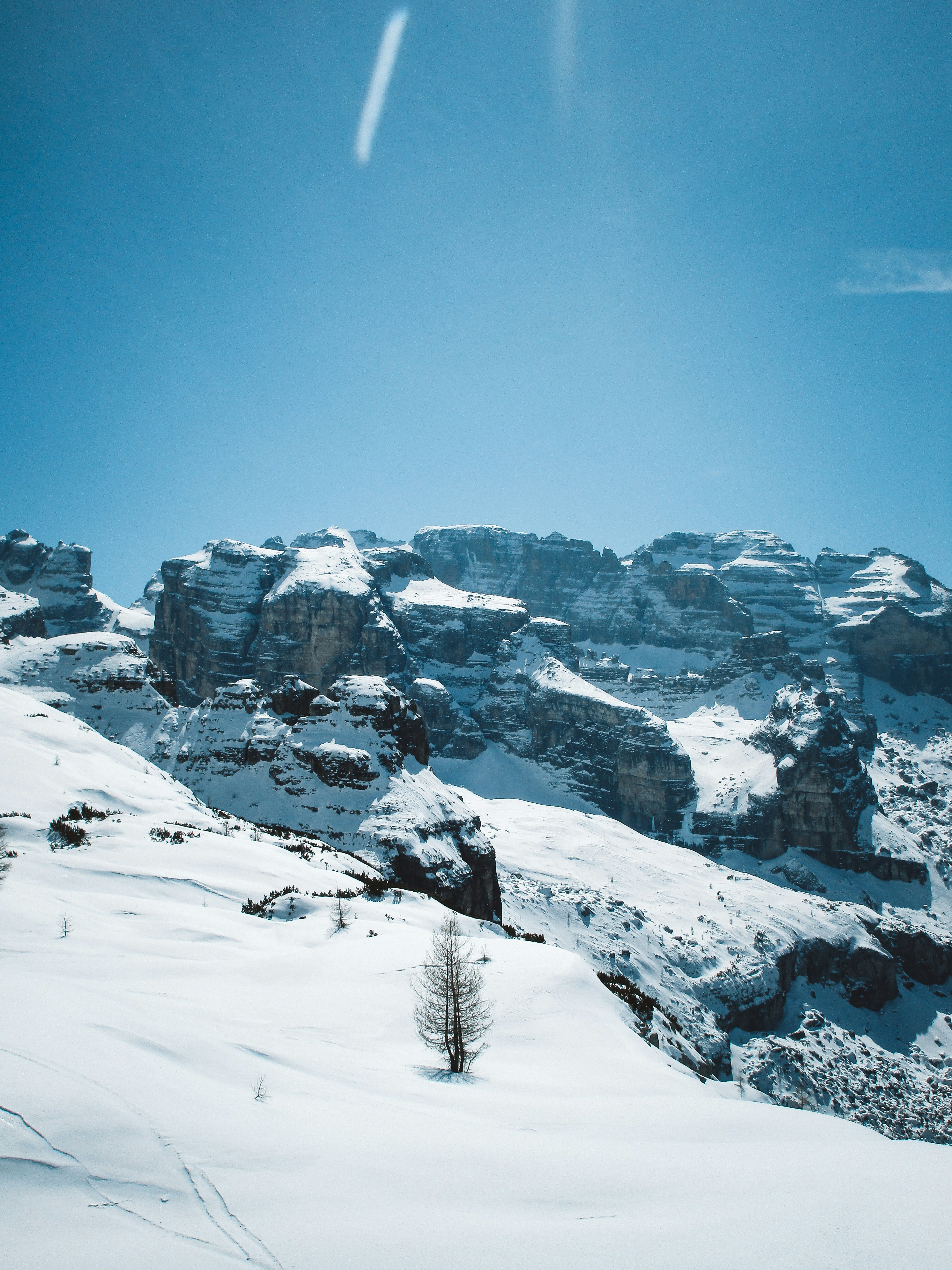 Snow-covered mountains under a clear blue sky