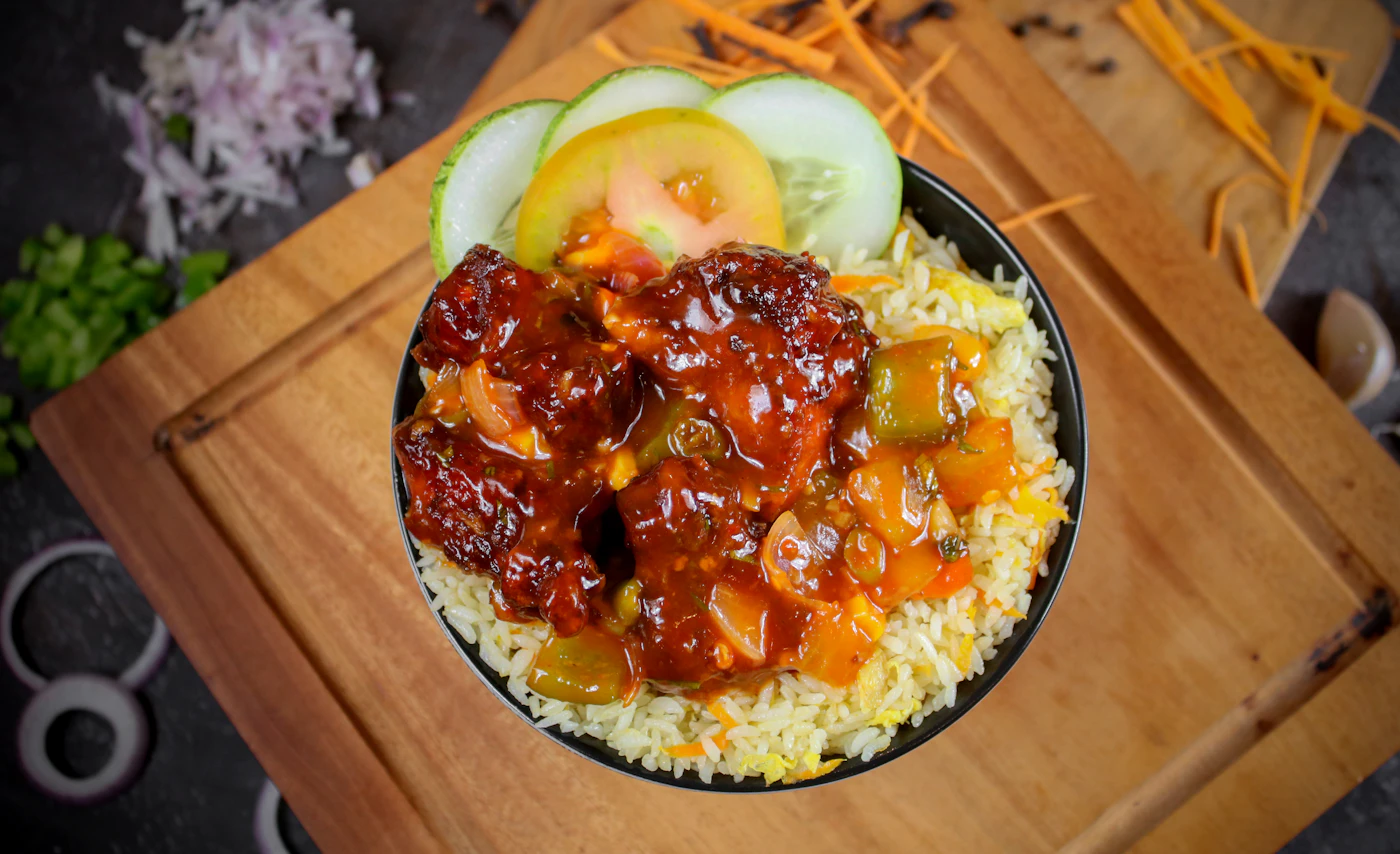 Glazed crispy chicken and vegetables over rice