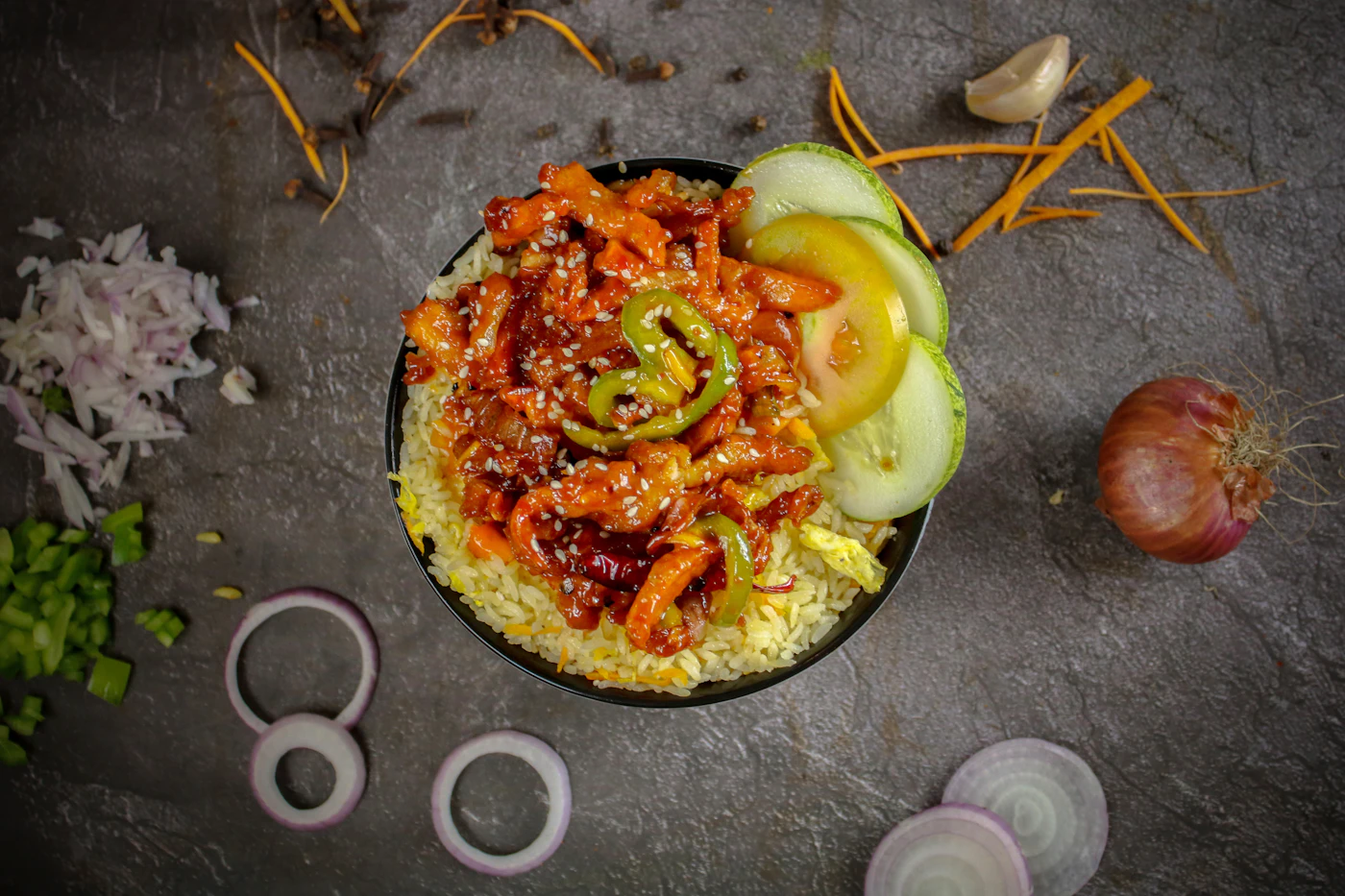 Orange glazed chicken rice bowl with peppers and onion