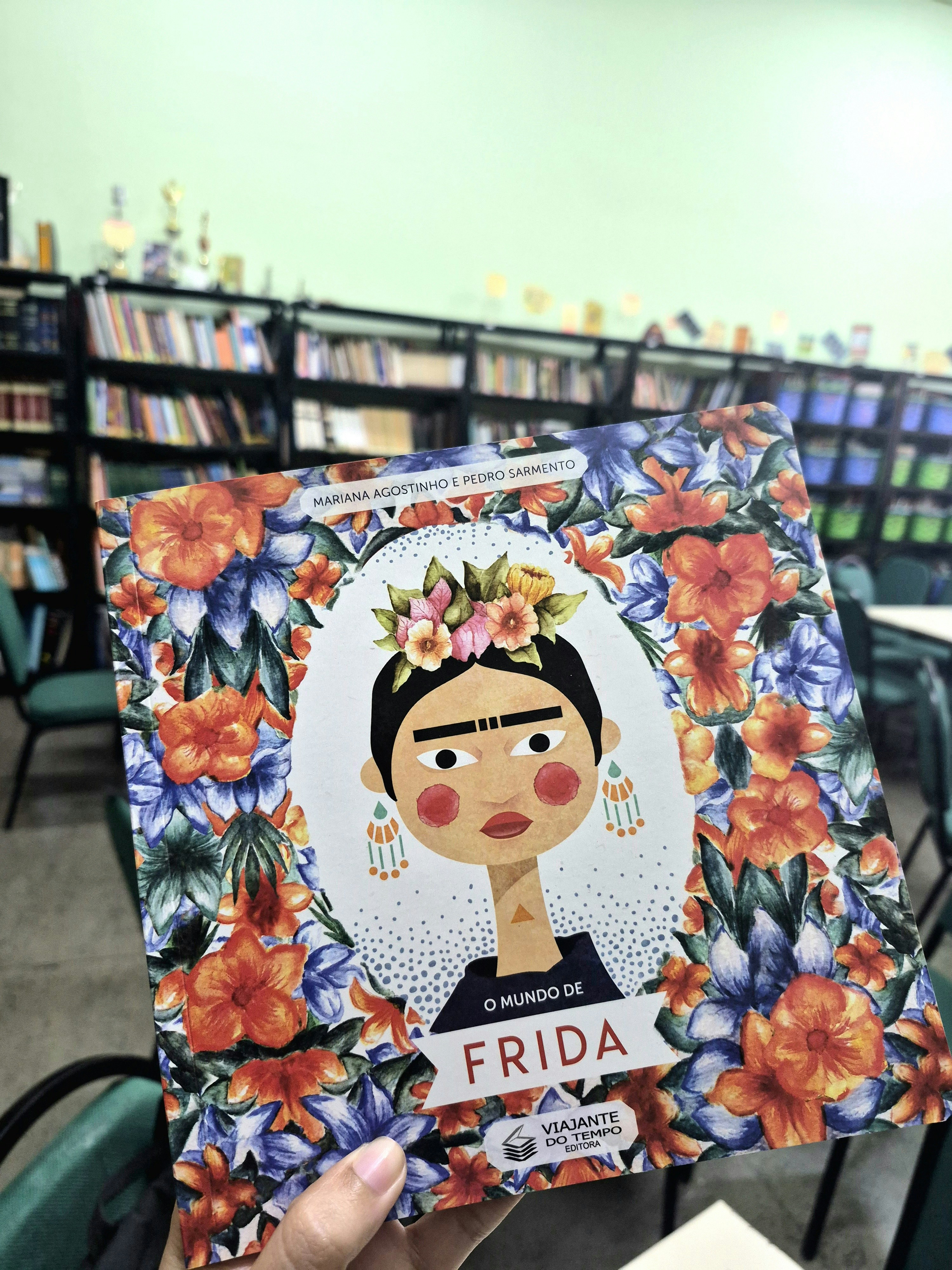 Book cover featuring frida kahlo illustration with floral border