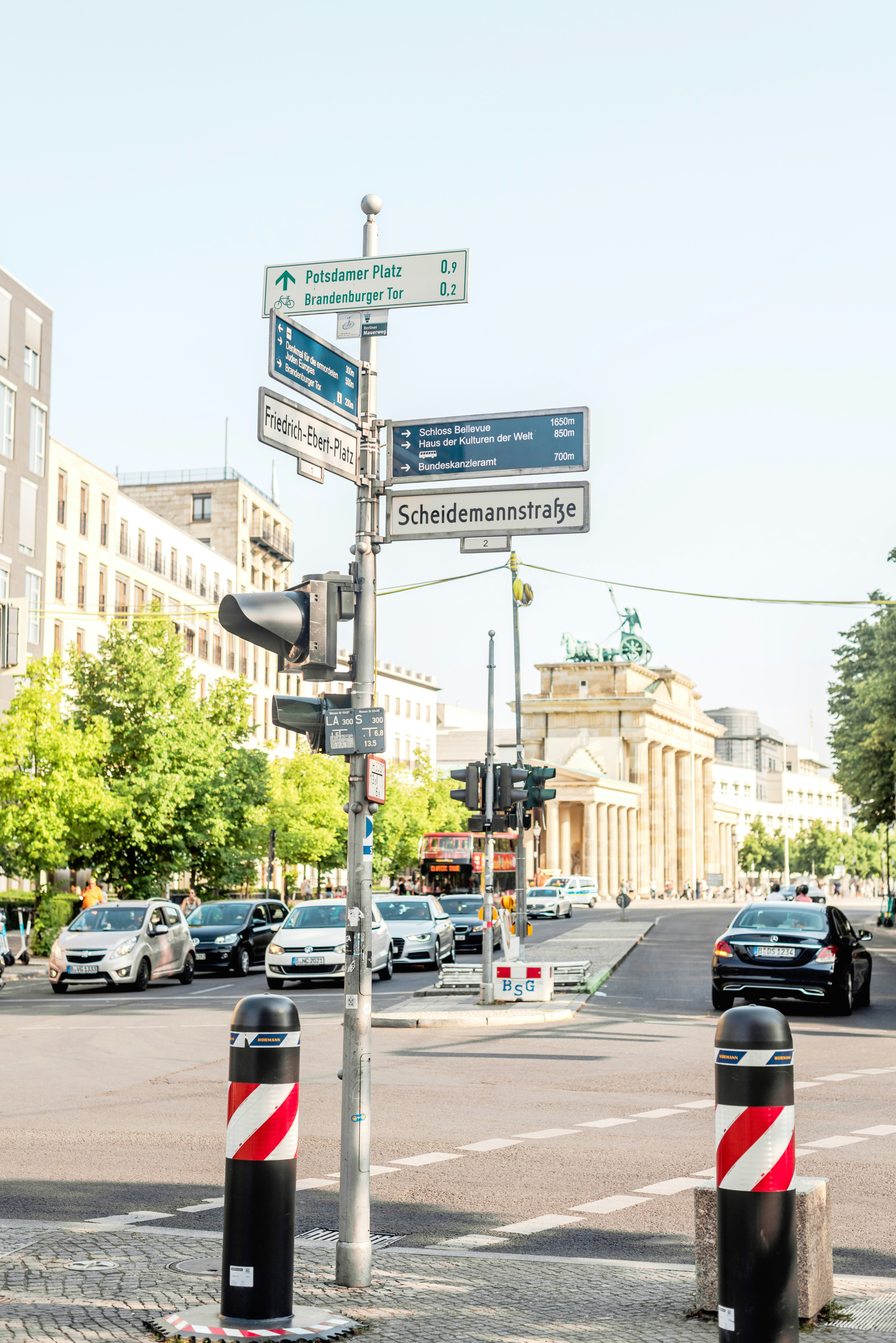 Street signs point towards brandenburg gate in berlin.