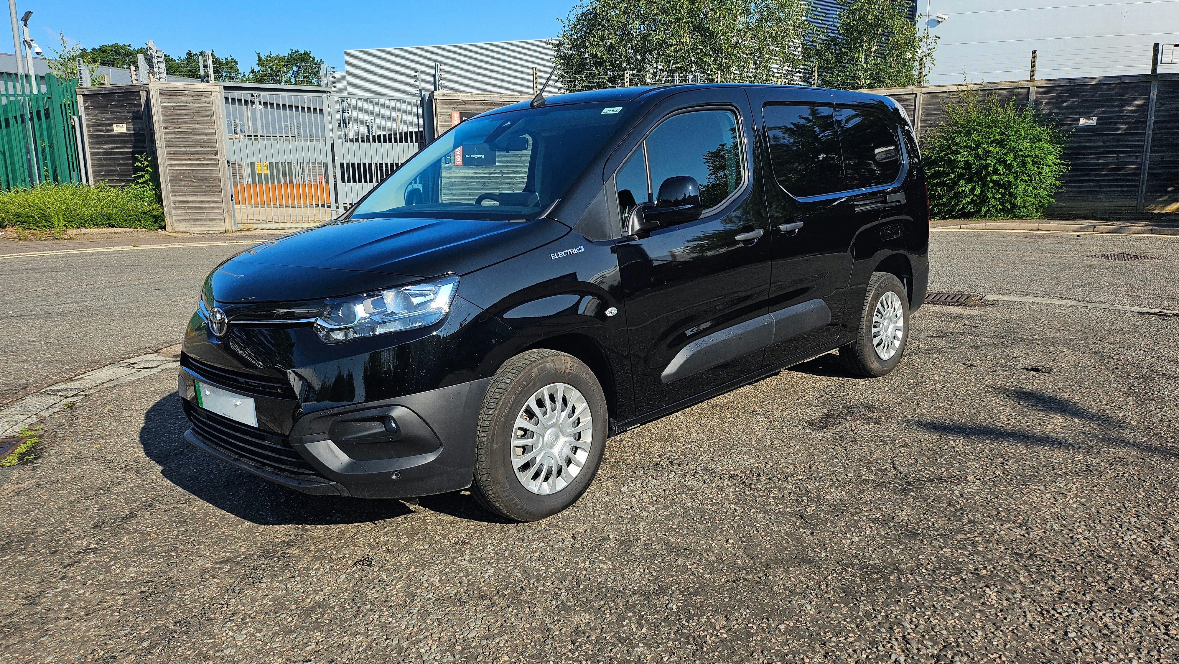 A black van parked on a paved surface.