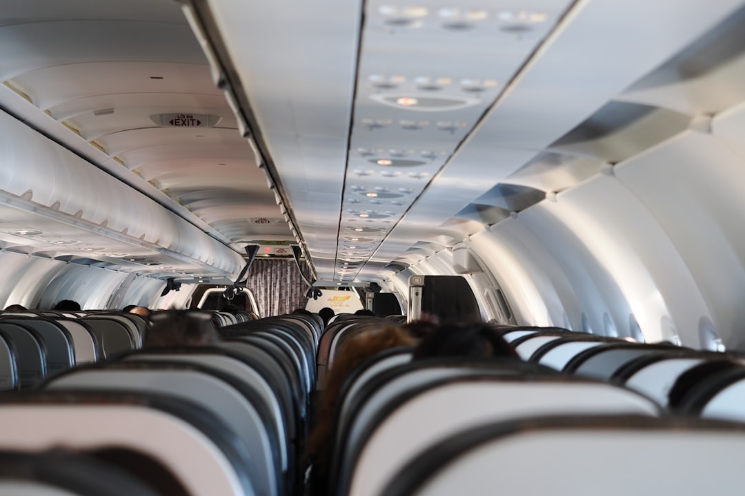 Interior view of an airplane cabin with passengers seated passengers.