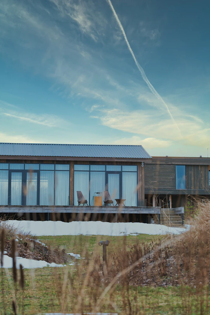 House with large glass windows and deck