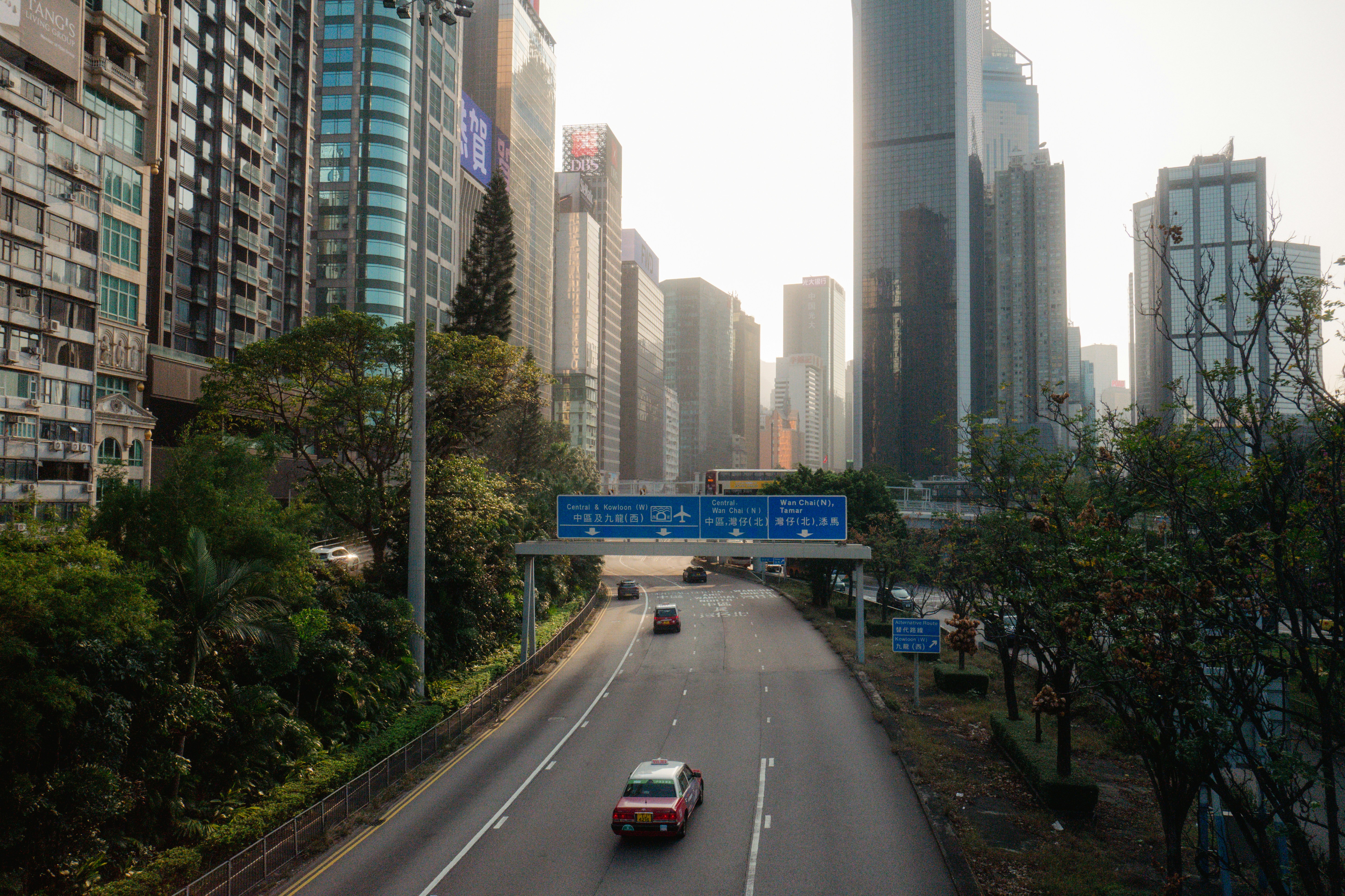 Cars on a highway surrounded by tall buildings.