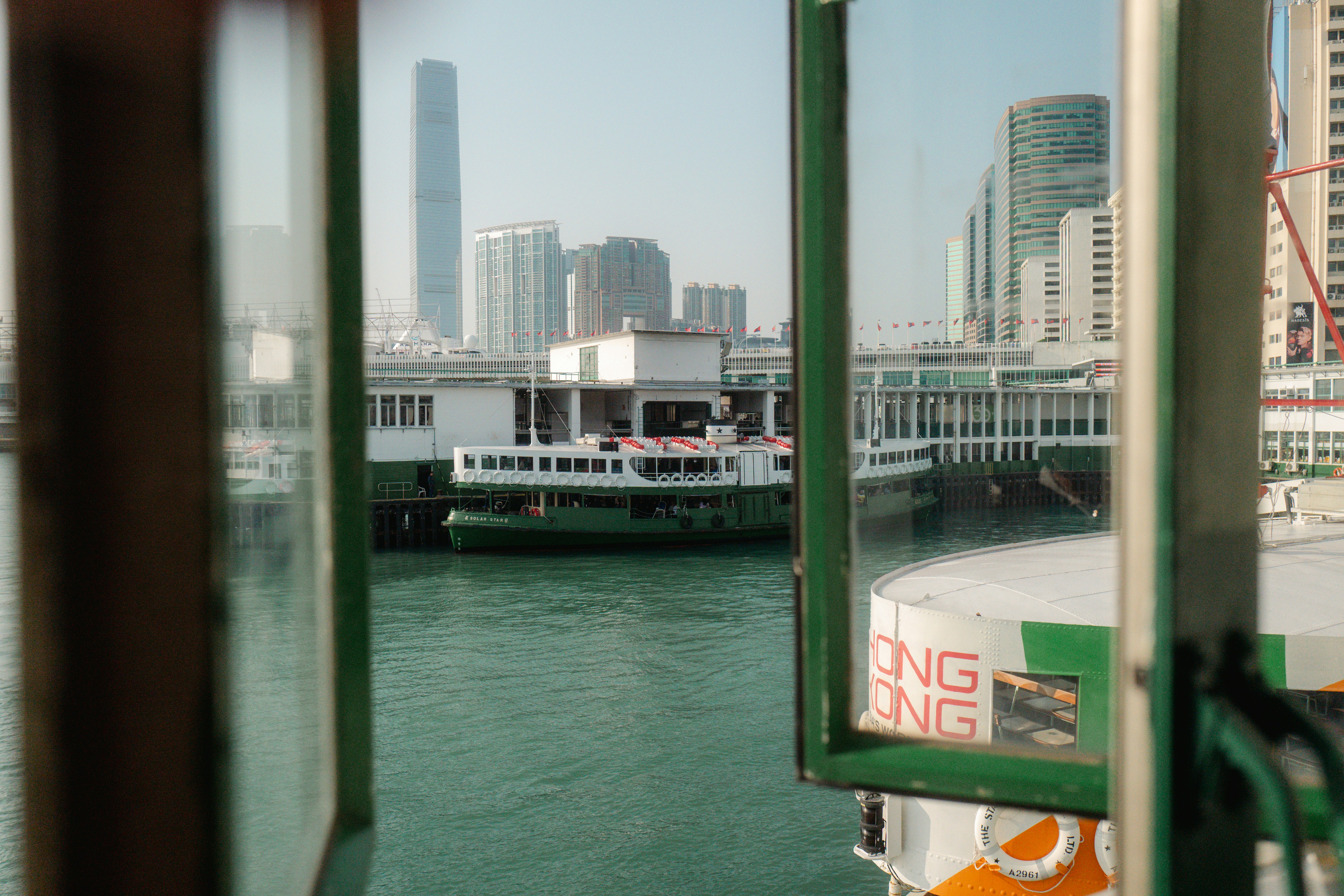 View of hong kong harbor with star ferry and buildings