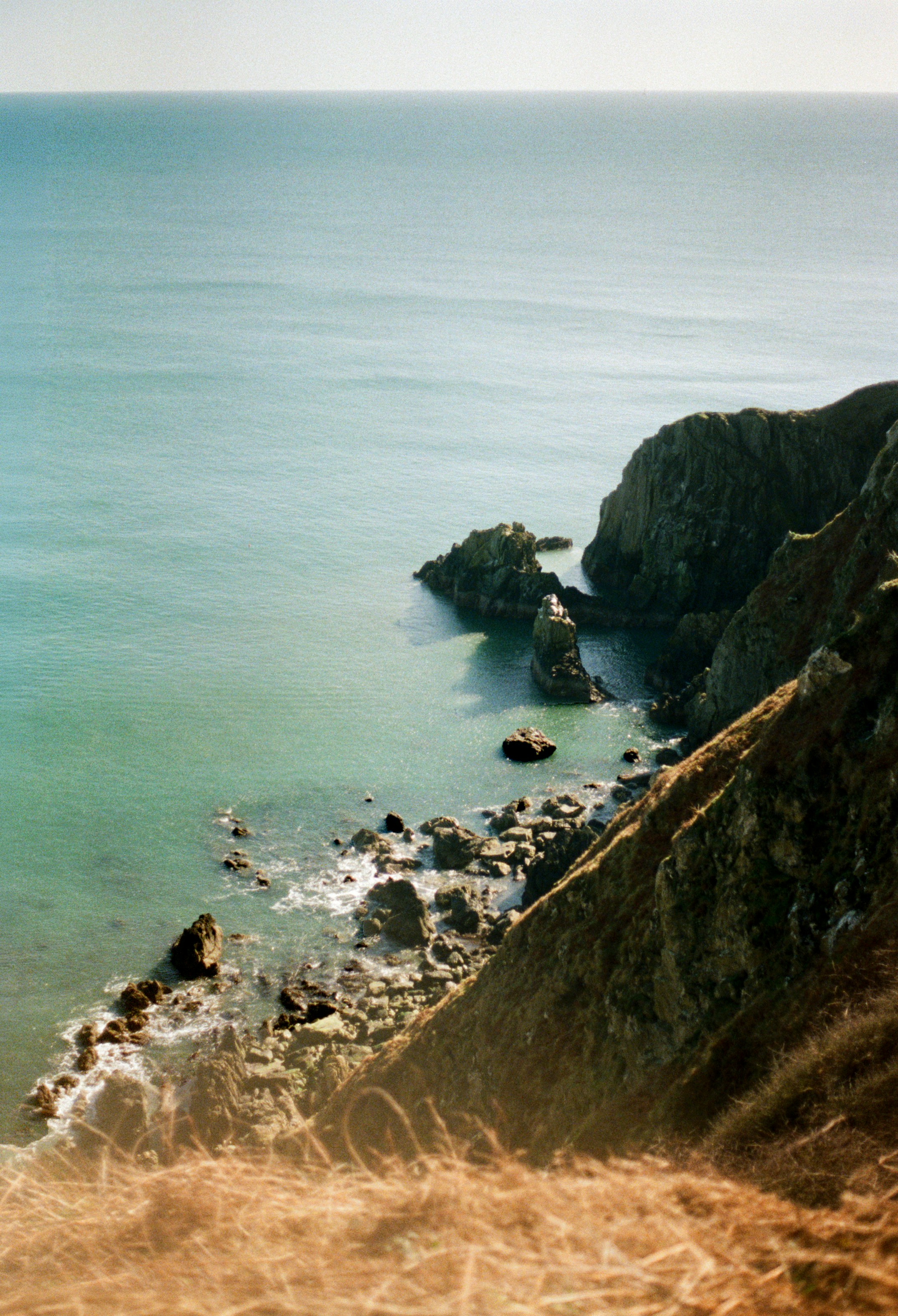 Rocky coastline meets the turquoise ocean water.