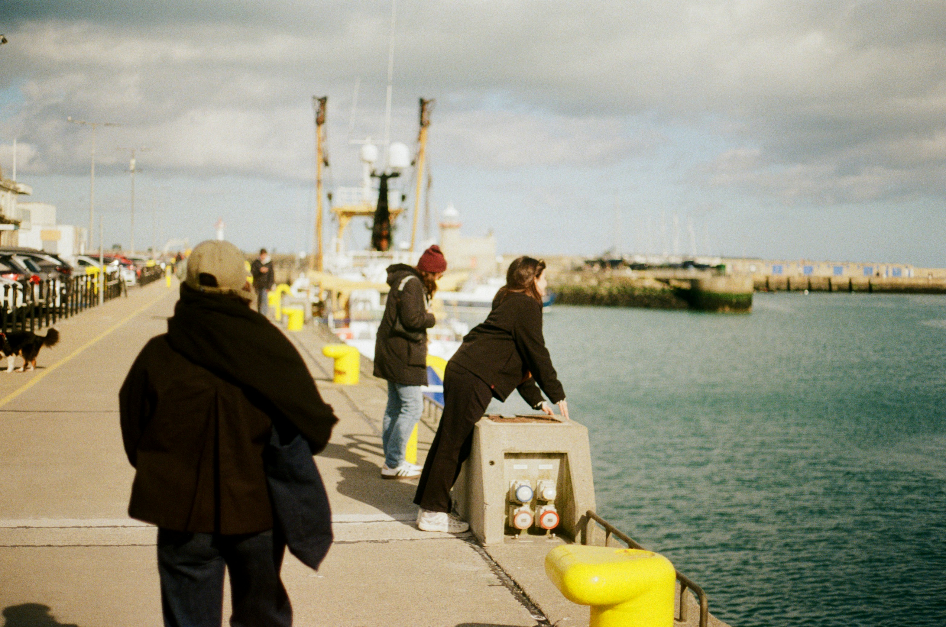 People standing on a dock by the water.