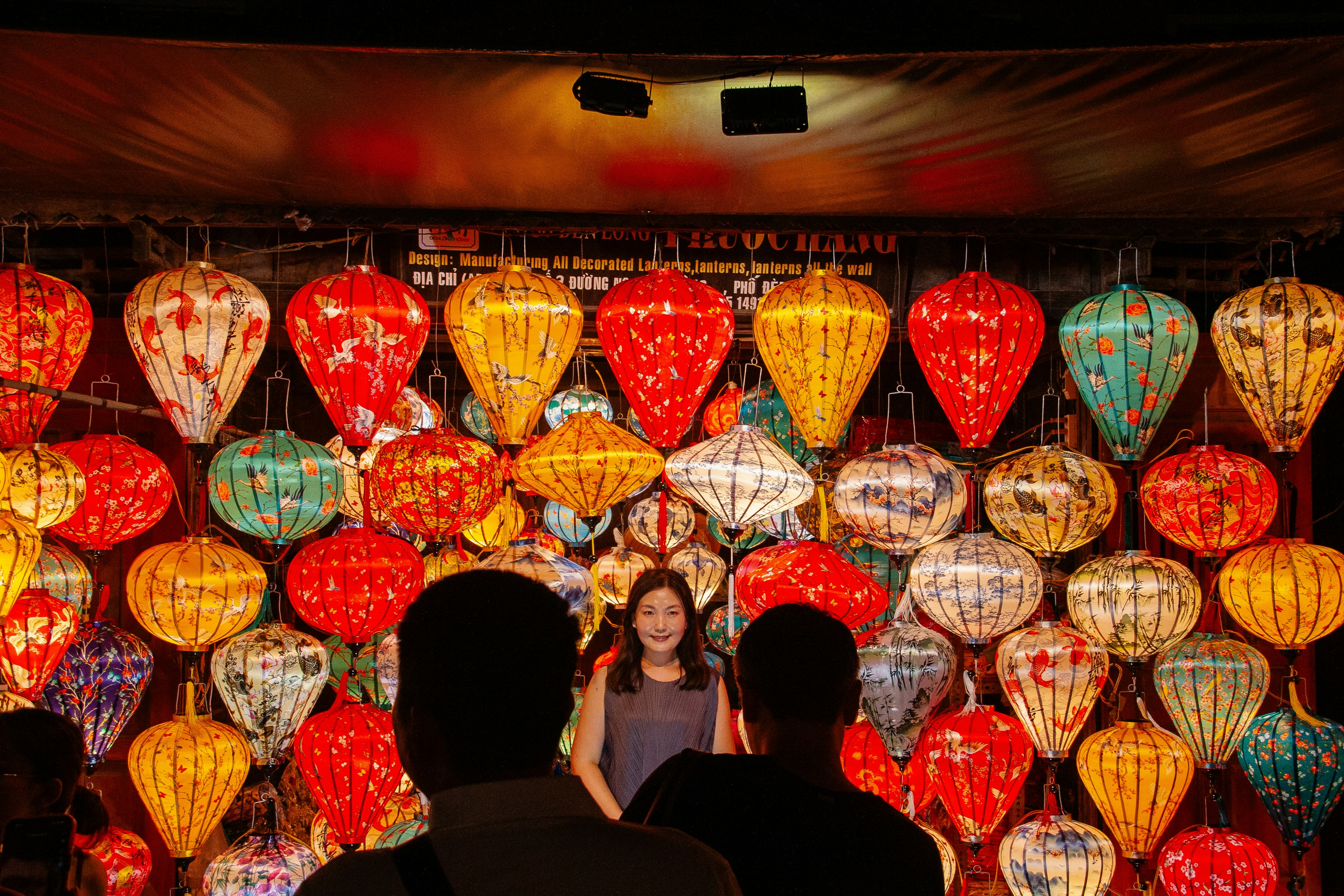 Colorful lanterns displayed with people watching