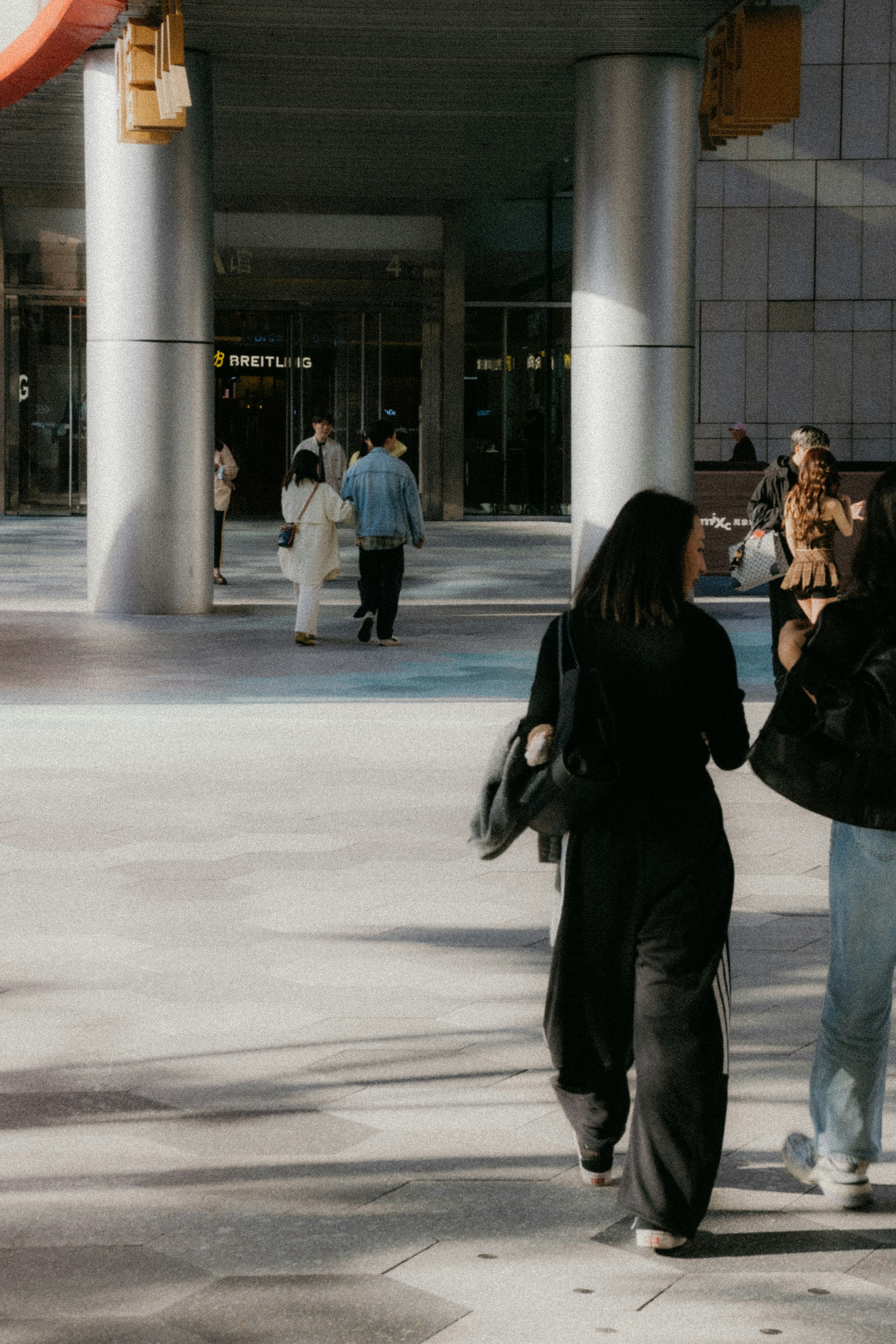 People walking on a sunny city street.