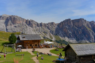 Mountain lodge with people relaxing on a sunny day
