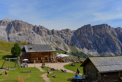 Mountain lodge with people relaxing on a sunny day