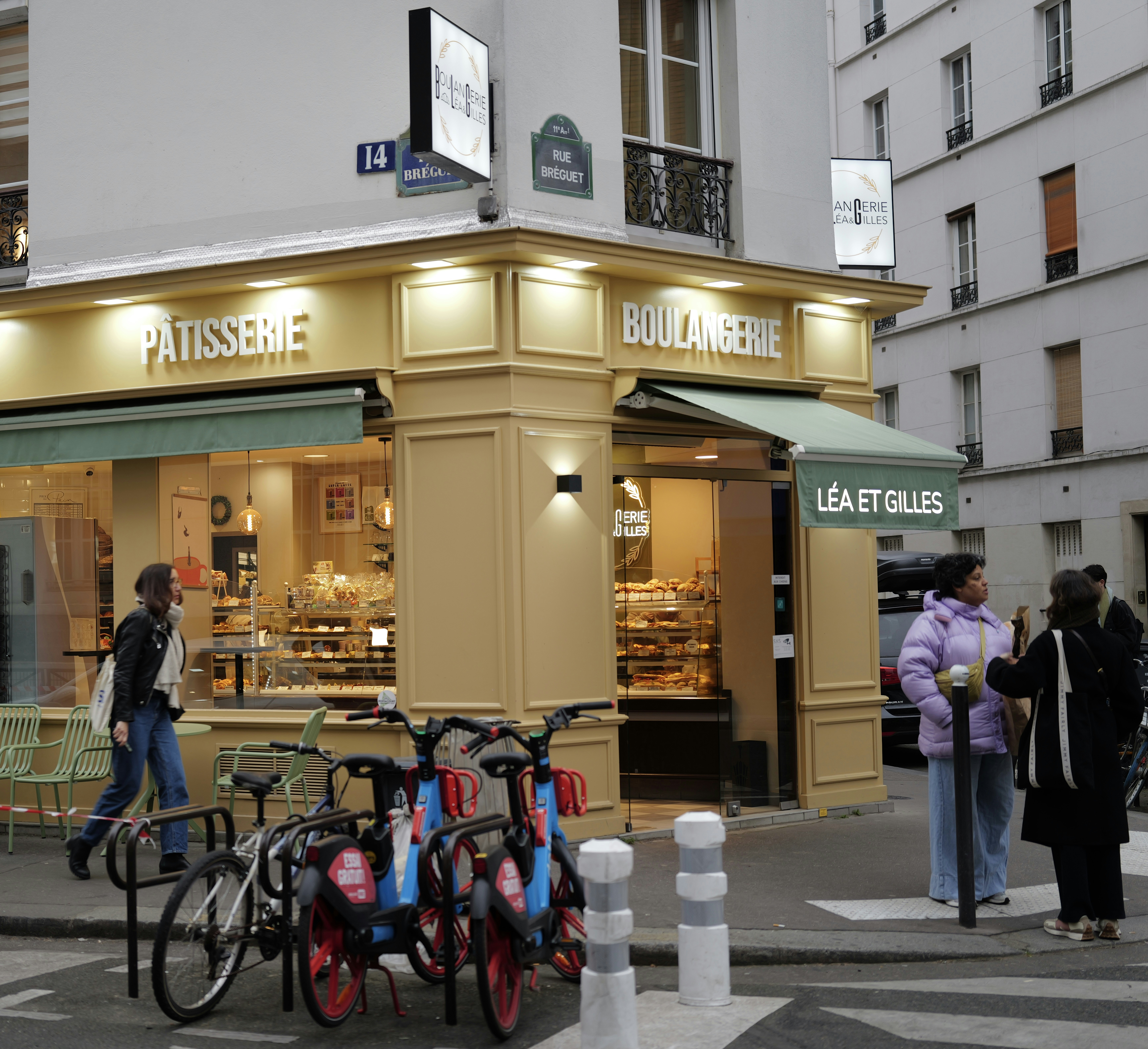 Corner bakery and pastry shop with bicycles outside seating outside