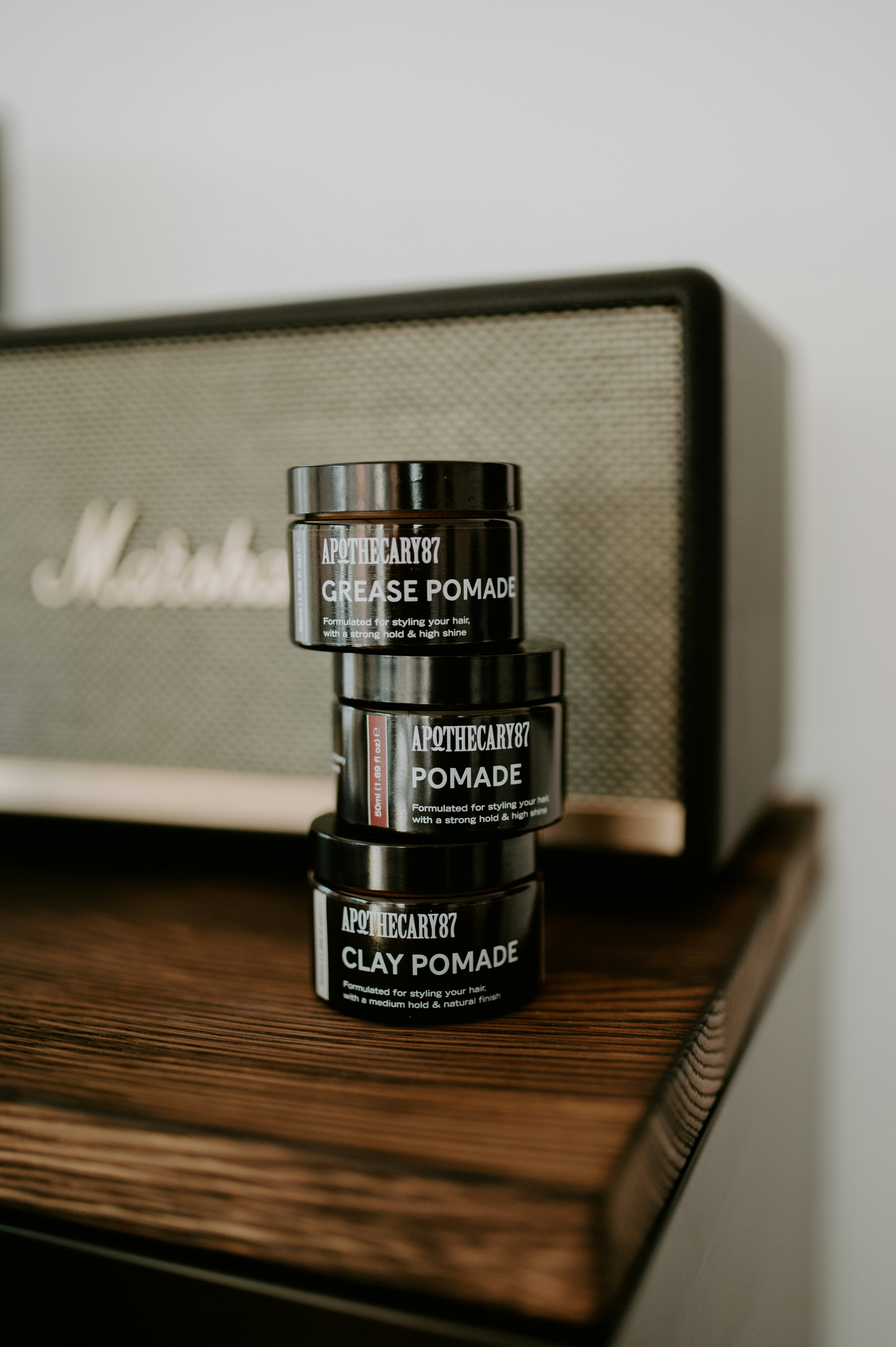 Three jars of apothecary hair pomade stacked.