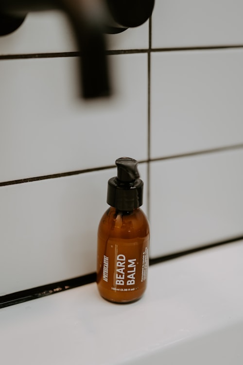 Beard care product bottle on a white surface