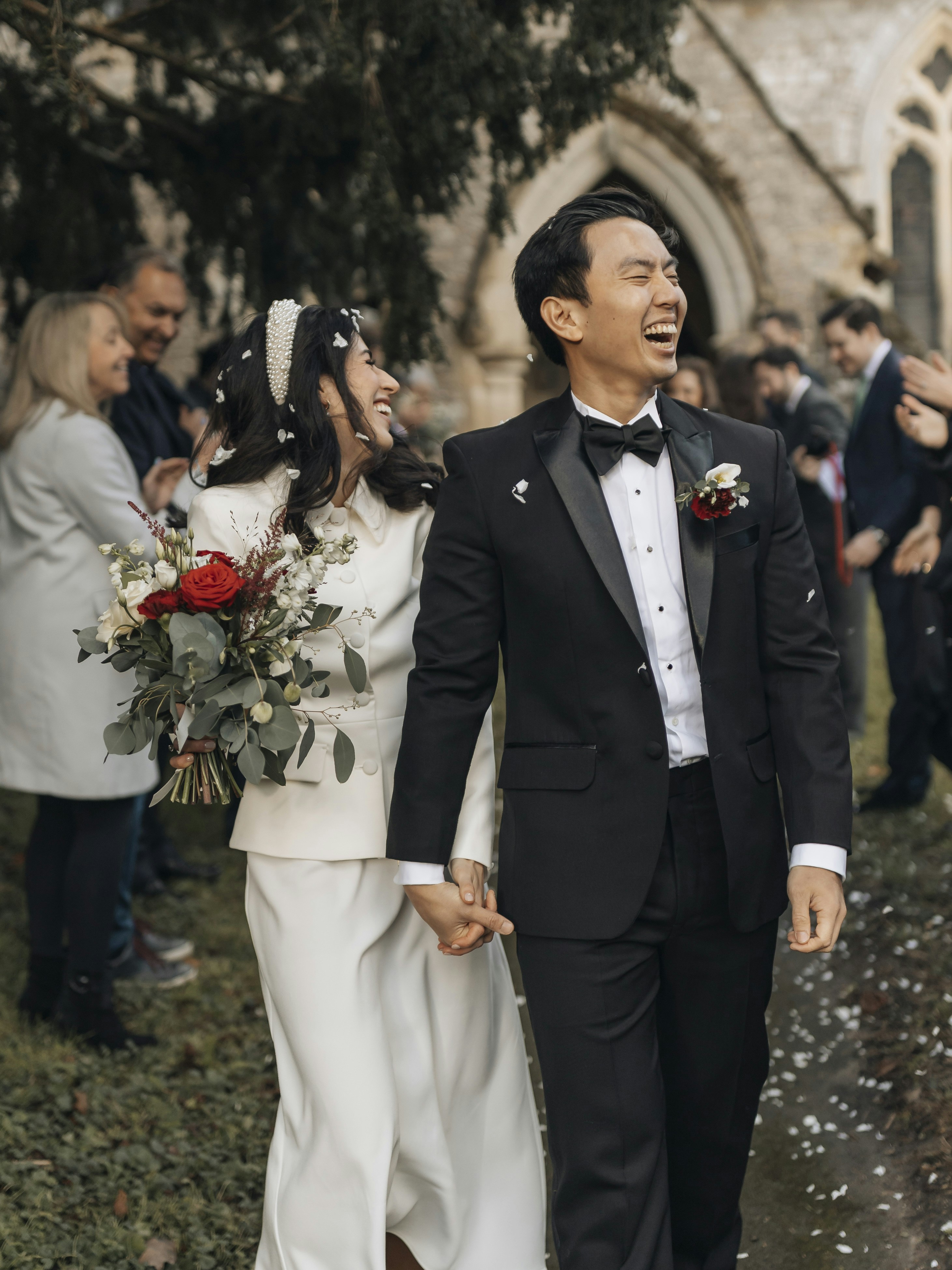 A happy couple walking hand-in-hand after their wedding.