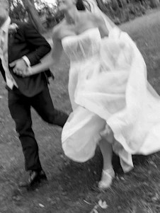 Bride and groom running together outdoors