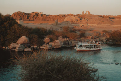 Cruise ship sailing past ruins on the Nile