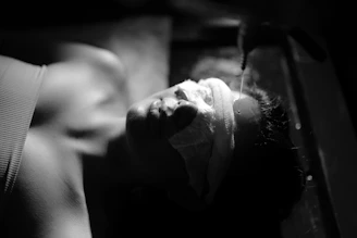 A person washing their face with a cloth.