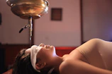 Oil treatment on her forehead