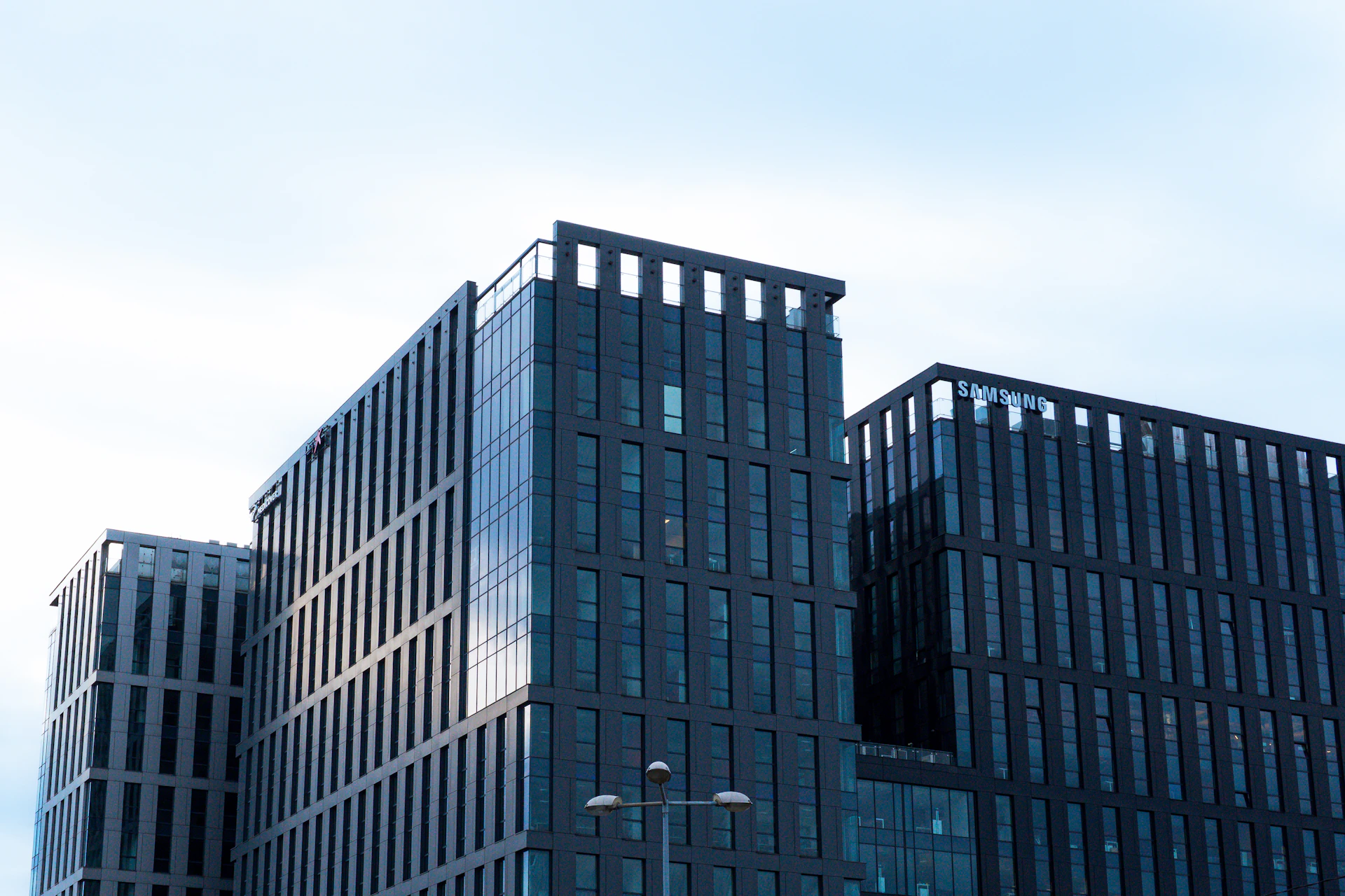 Modern glass office buildings against a pale sky