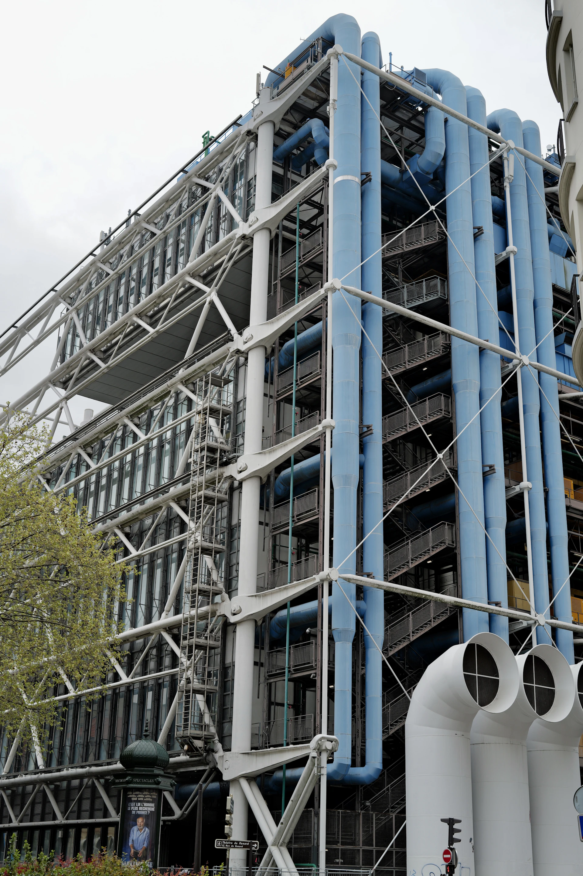 Modern building with blue pipes and steel structure