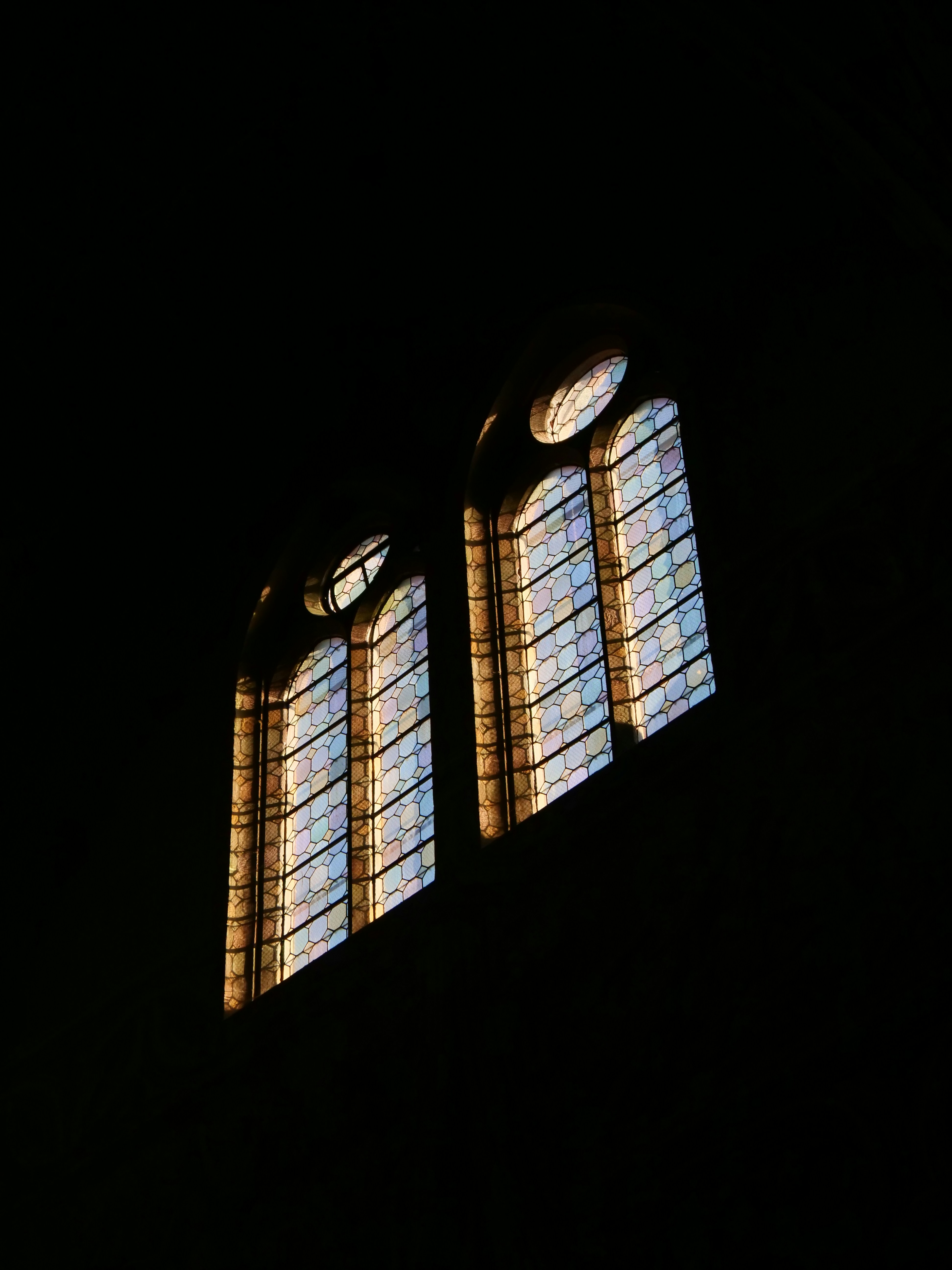 Gothic arched windows illuminated by warm sunlight