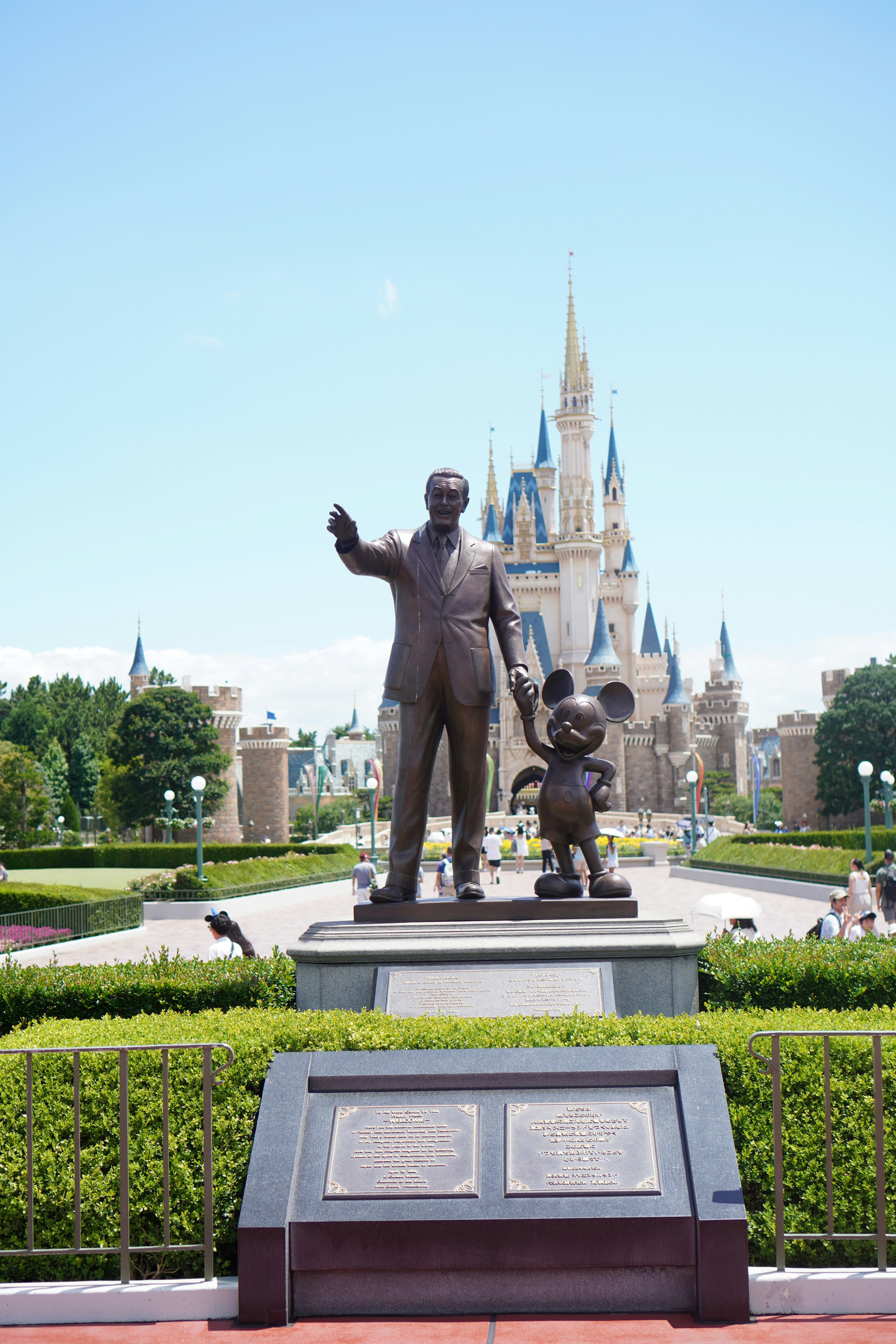 Walt disney and mickey mouse statue with castle