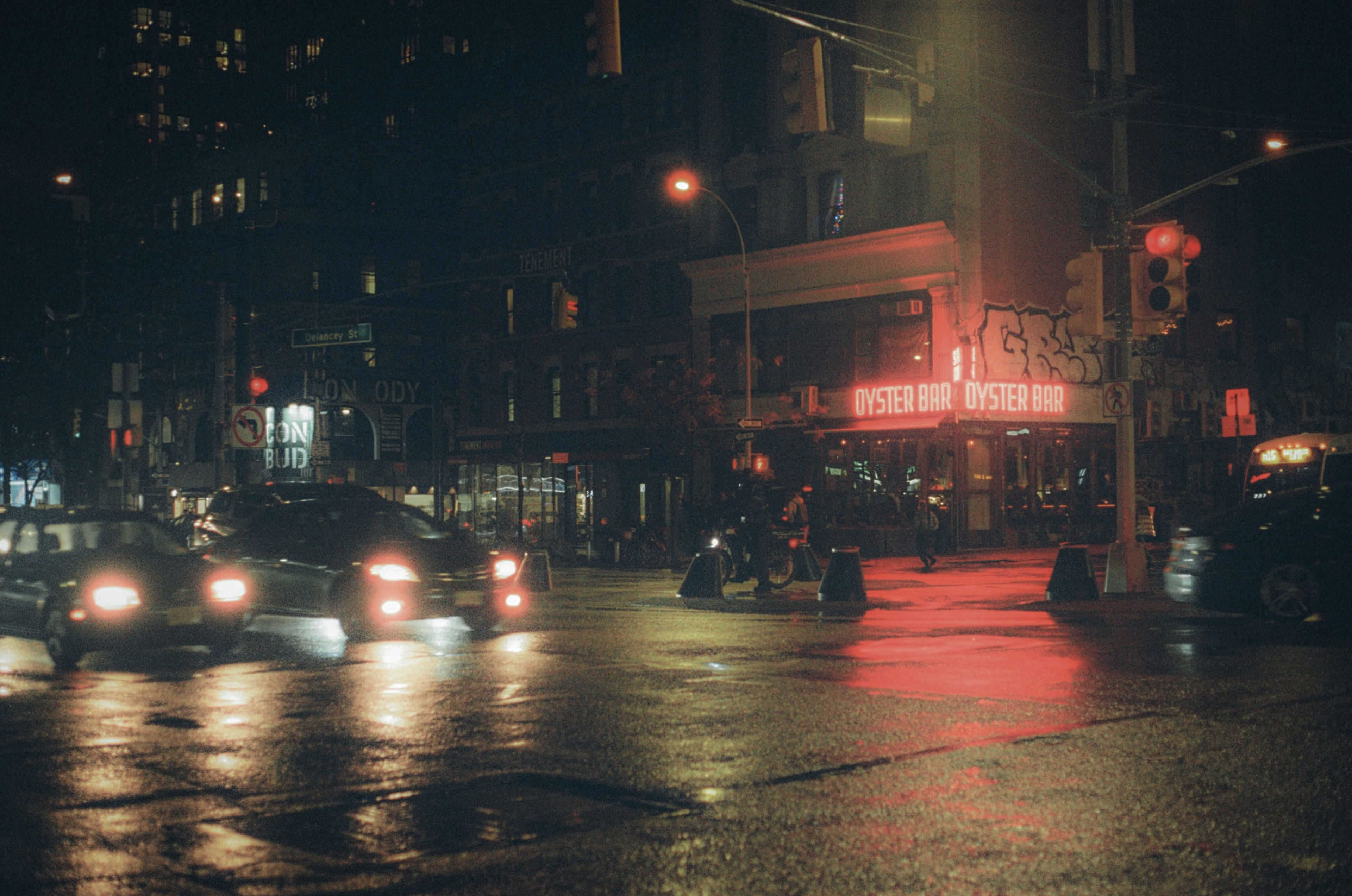 Cars driving on a wet street at night