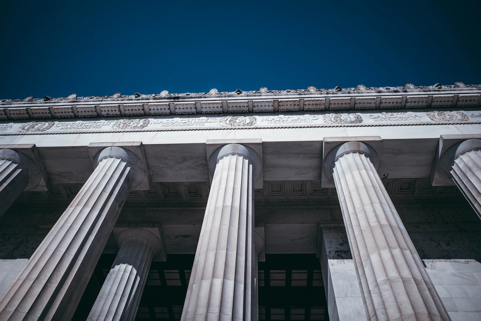 Grand neoclassical building columns against a blue sky