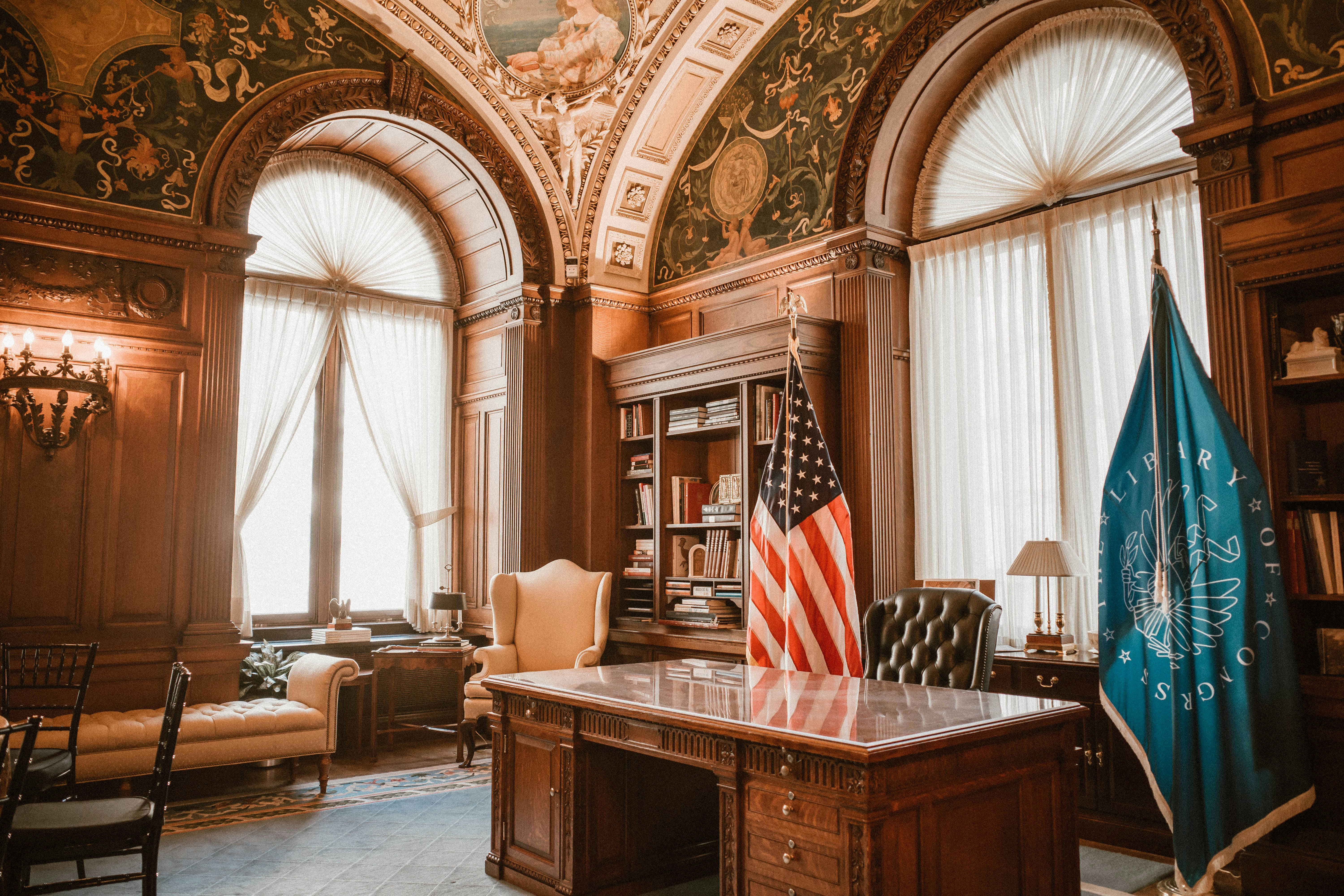 Elegant office with american flag and presidential desk.