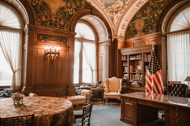 Ornate office with american flag and antique furniture