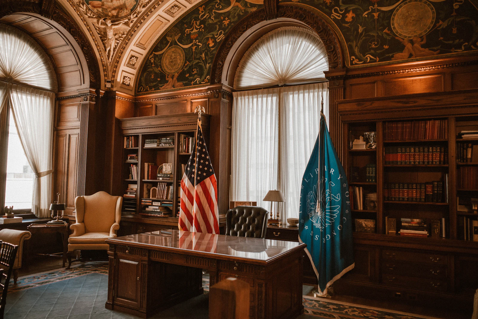 Government office interior with US flags and bookshelves