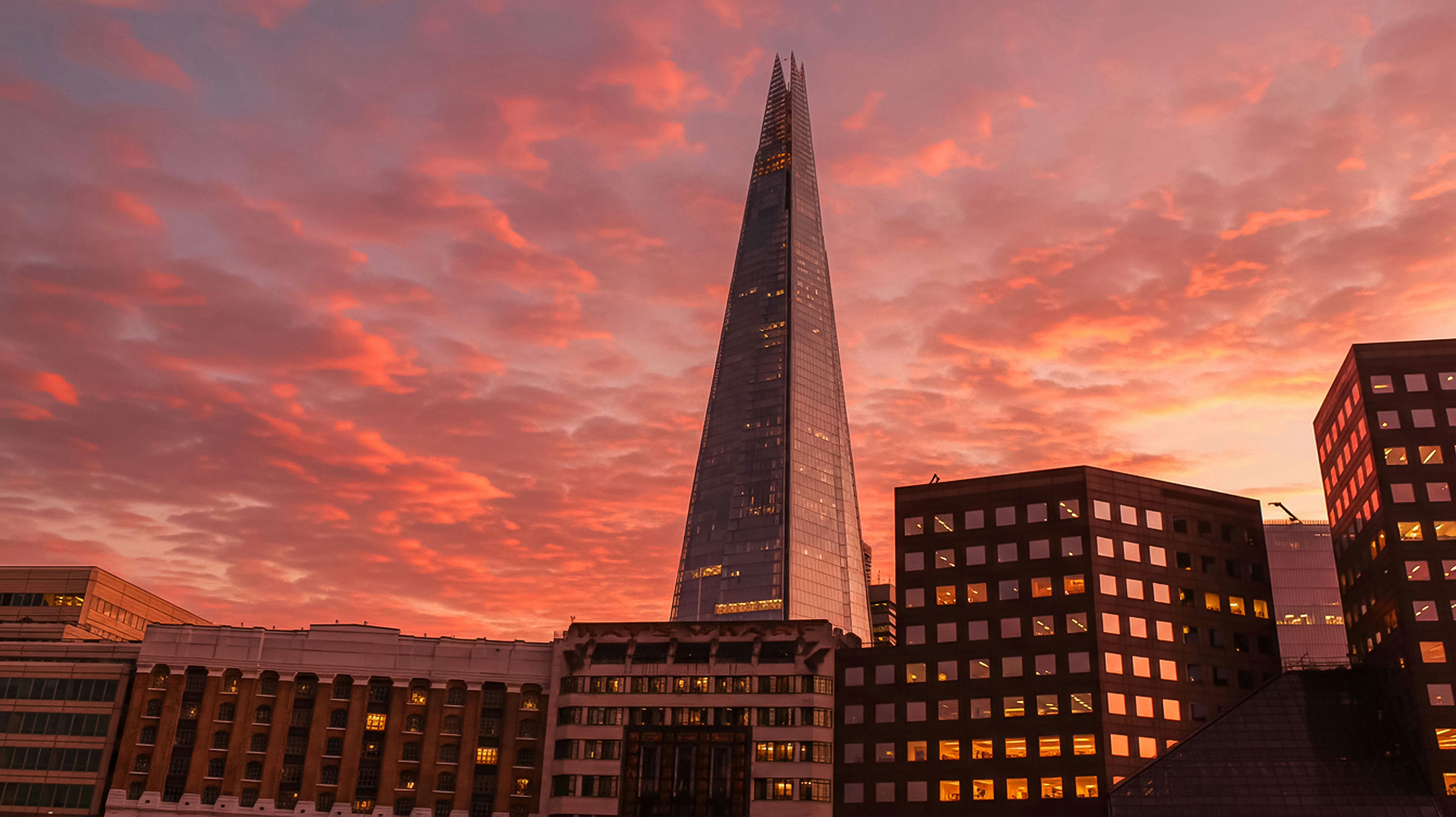 Skyscraper against a dramatic sunset sky