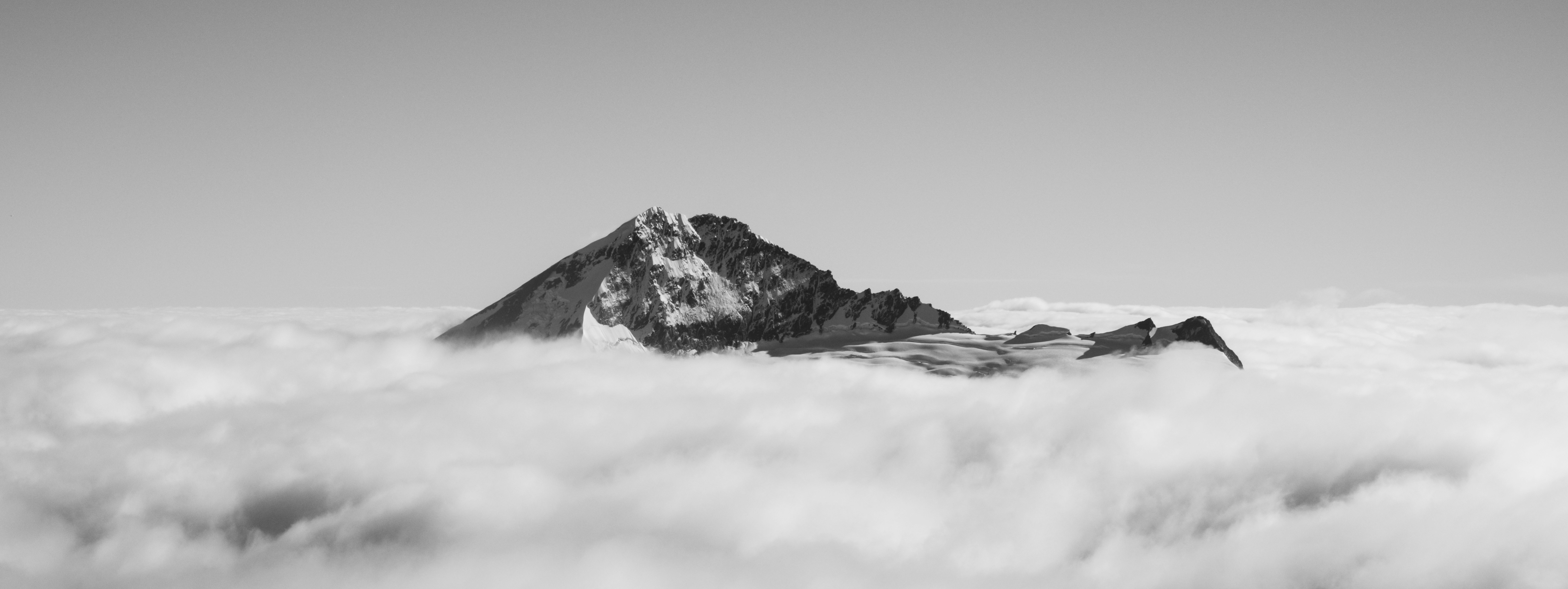 Mountain peak emerging from a sea of clouds